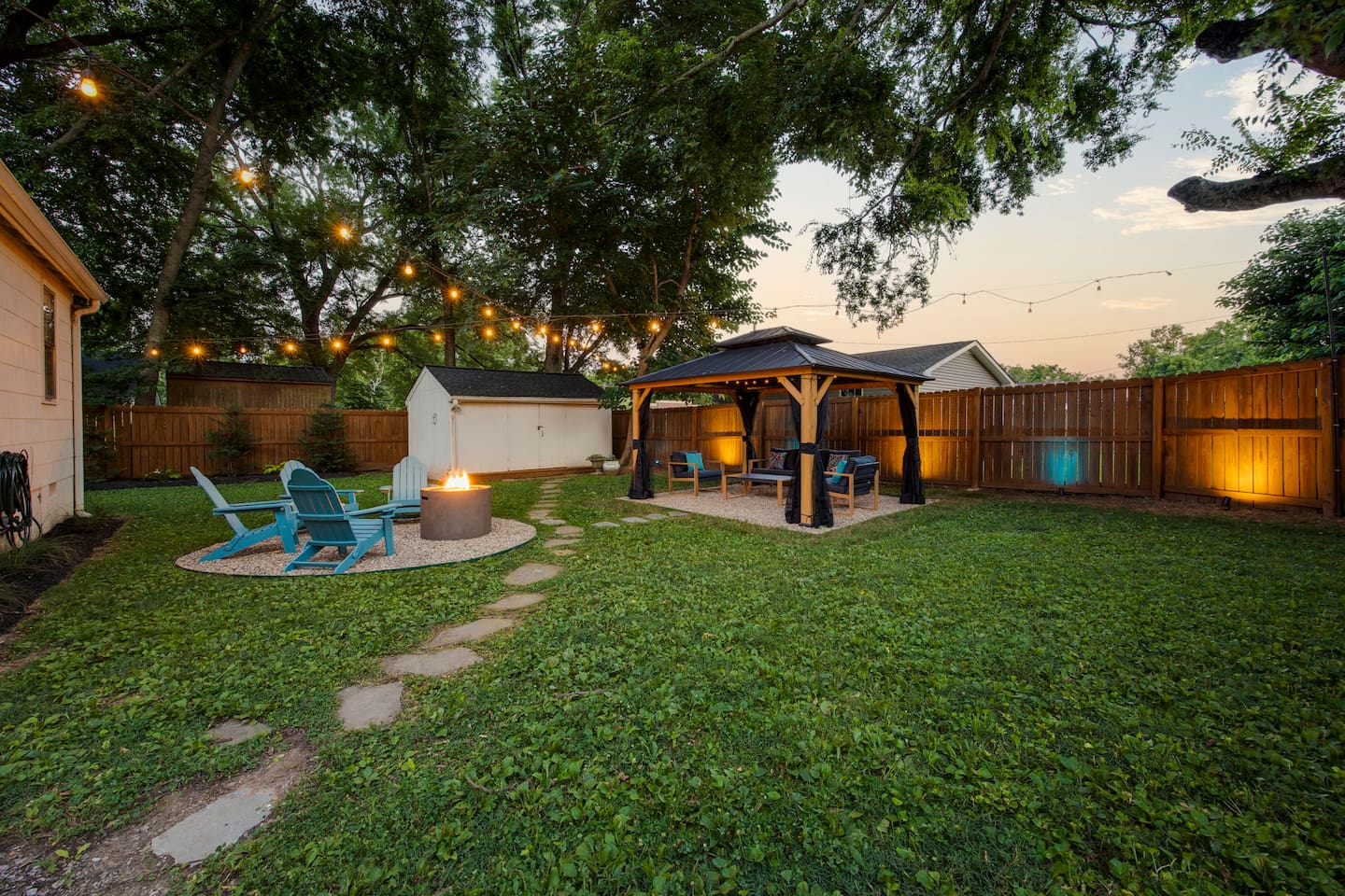 Backyard fire pit and seating area, covered gazebo hangout, and fully enclosed yard with privacy fence.