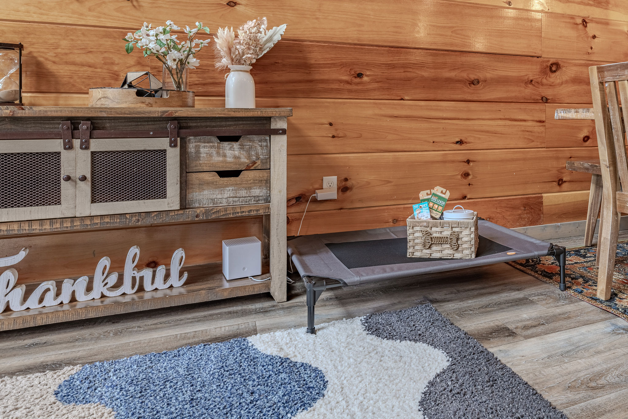 The Collector’s Gallery is the main living room, offering warm cabin character, comfortable seating, a Smart TV, and a cozy place to gather after Smoky Mountain adventures.