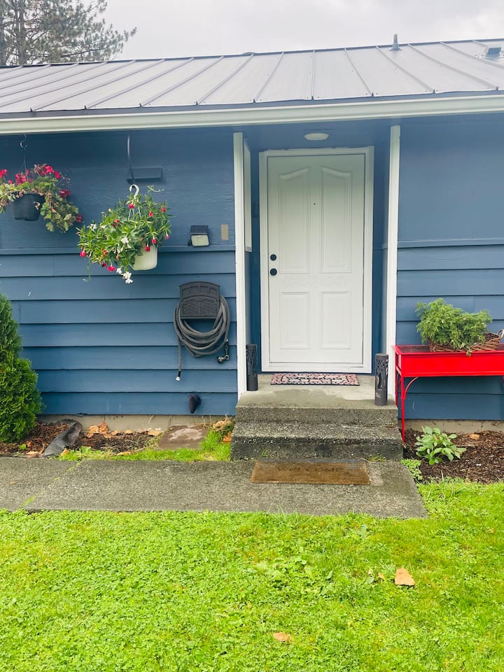 The front door welcomes guests with charm and a hint of the home’s inviting character.
