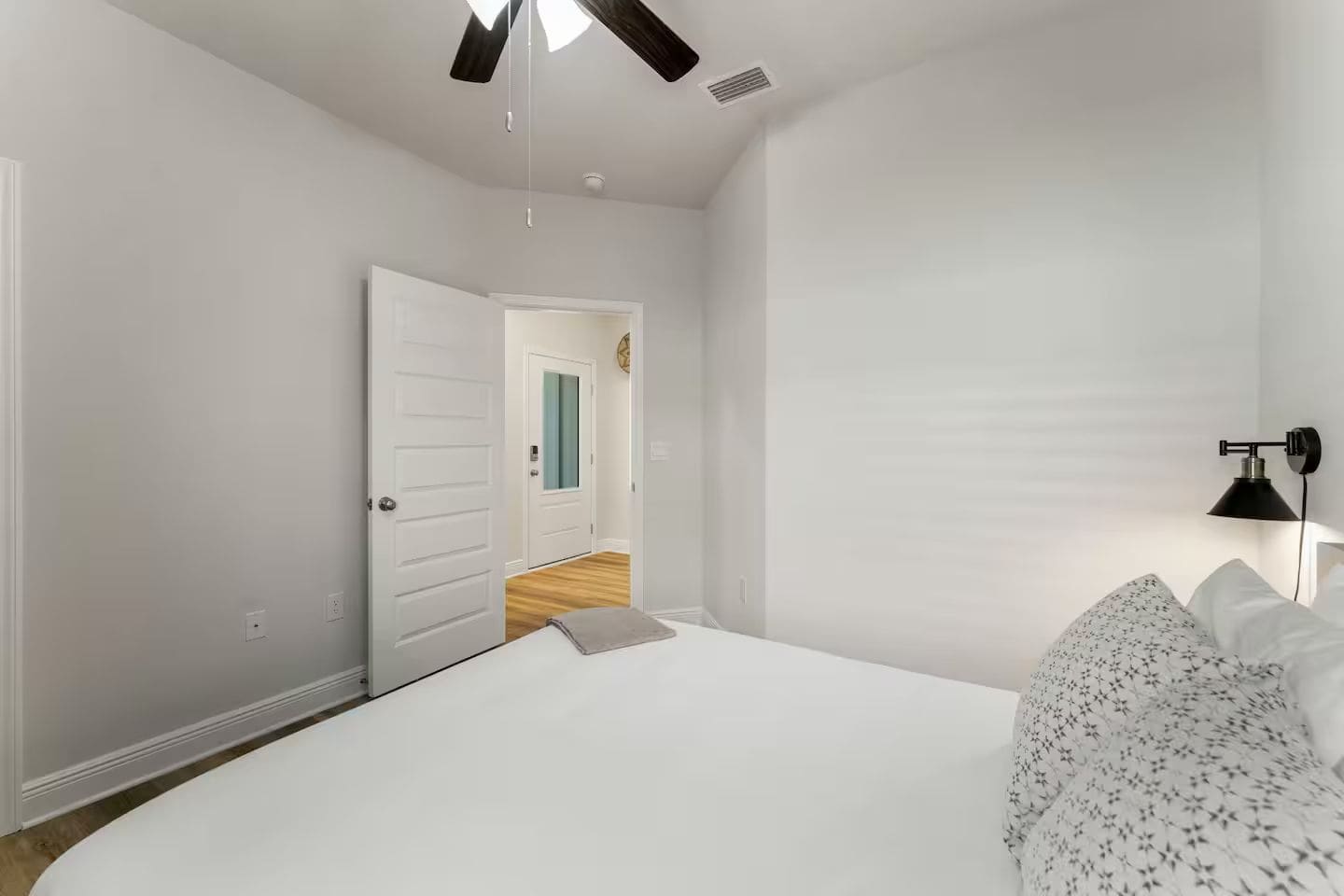 Modern bedroom with ceiling fan, and elegant bedside table lamps