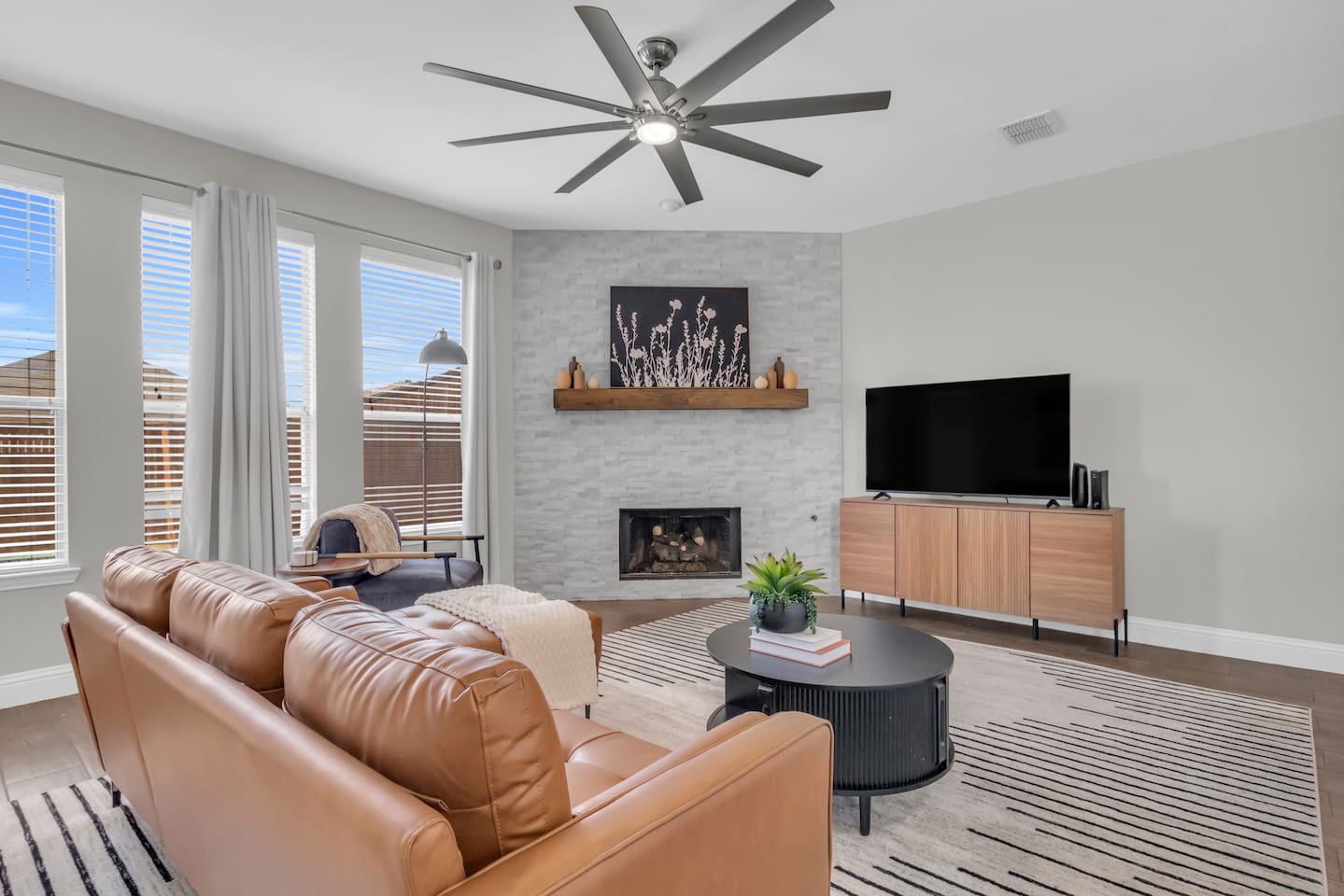 Spacious living room with a warm, inviting layout designed for families and groups to relax together comfortably.