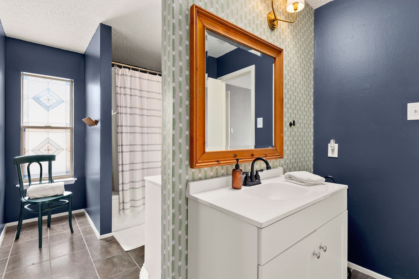 The second inviting bathroom comes with a bathtub and a shower.