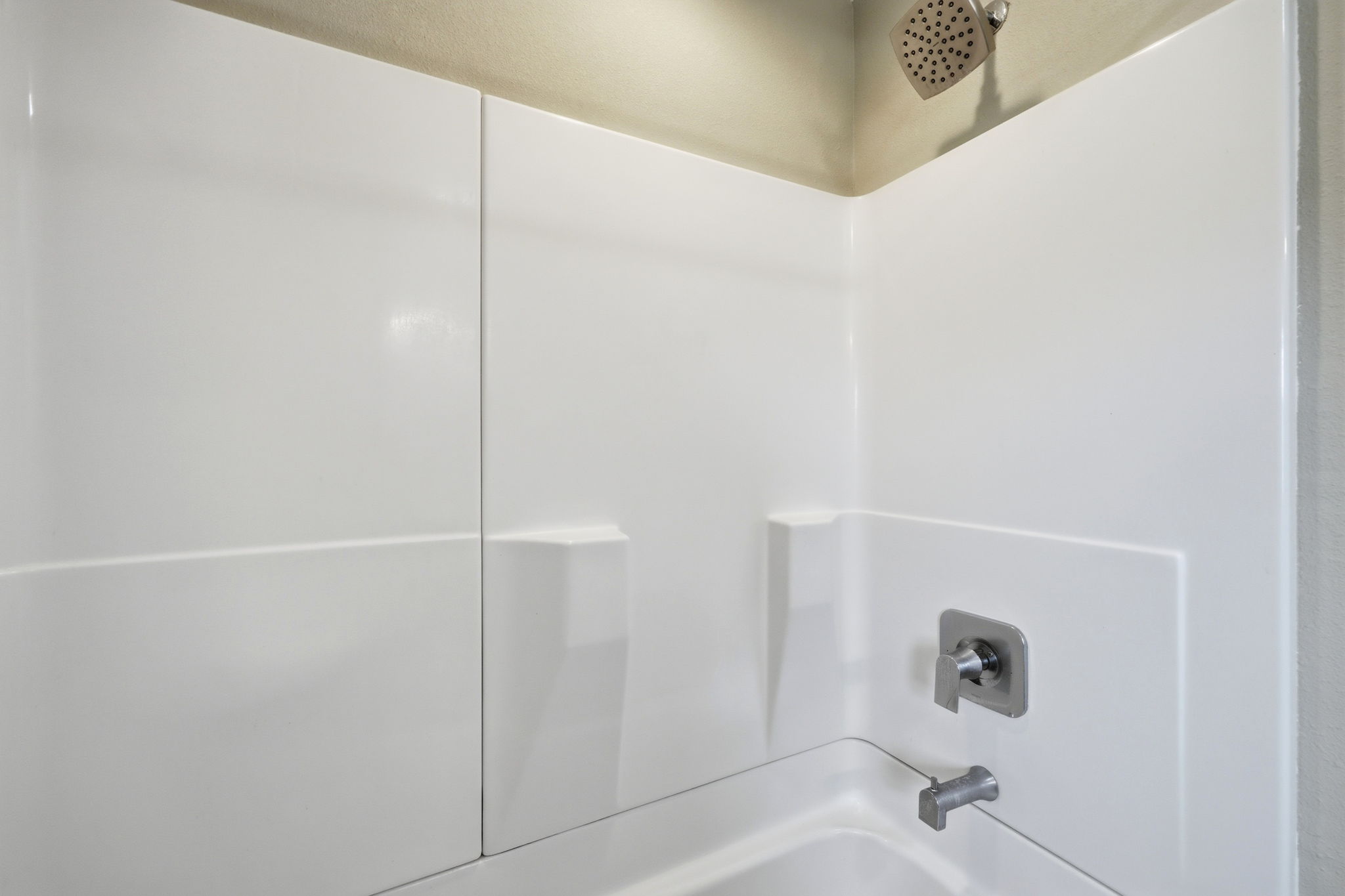 The ensuite bathroom offers a versatile space with both shower and tub options.