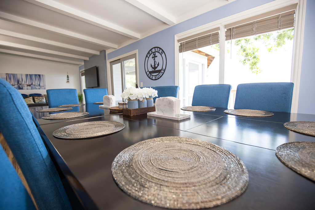 Gather around the dining table for family meals, laughter, and conversation with lake views just outside