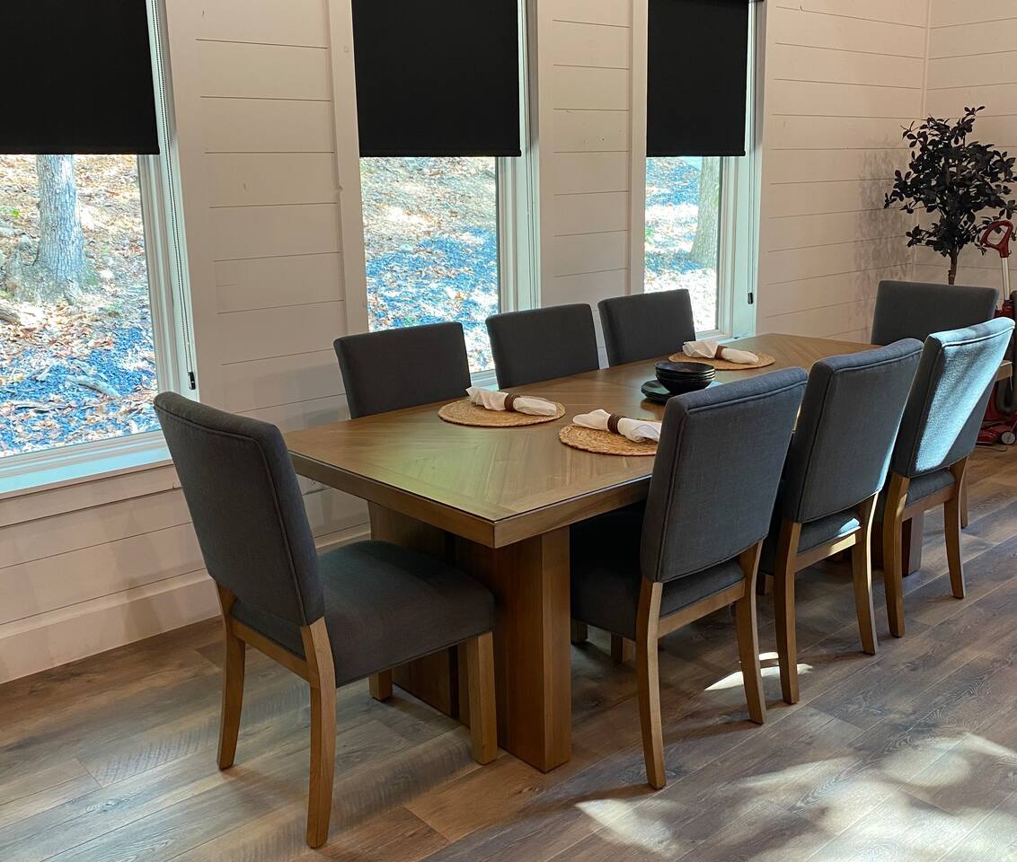 Dining table has eight chairs and an additional table leaf to extend 18"