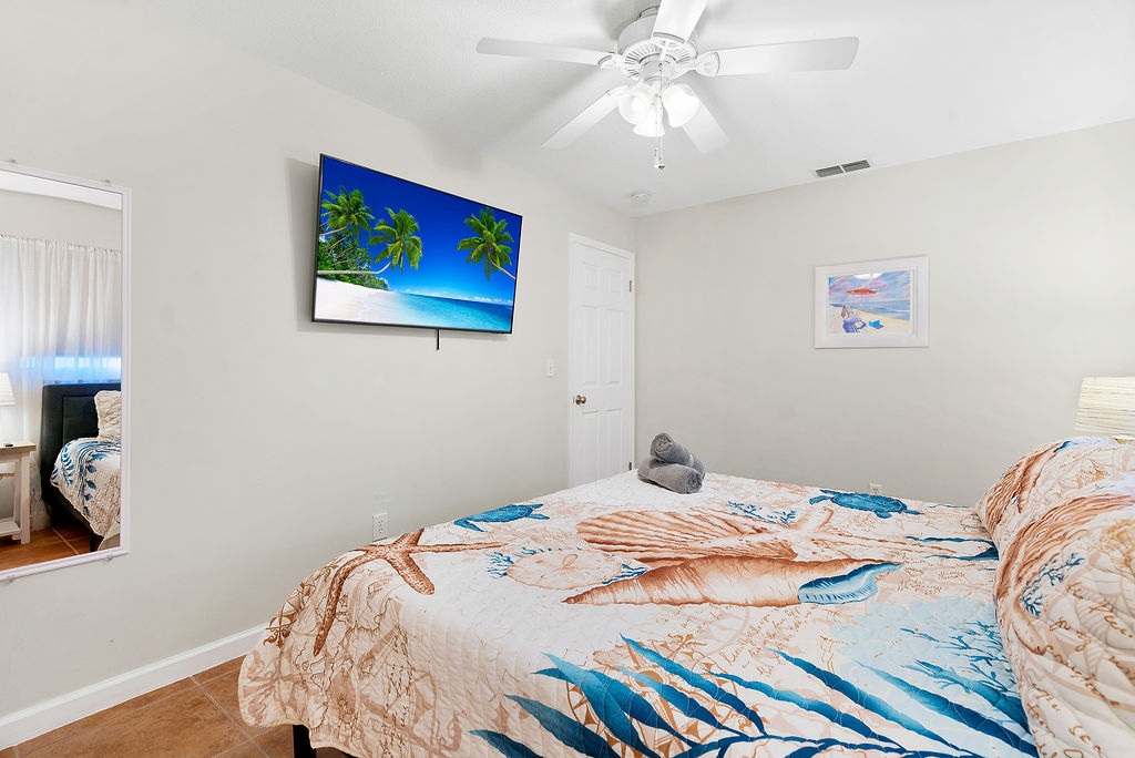 Bedroom 2 offers a king bed and smart TV,
