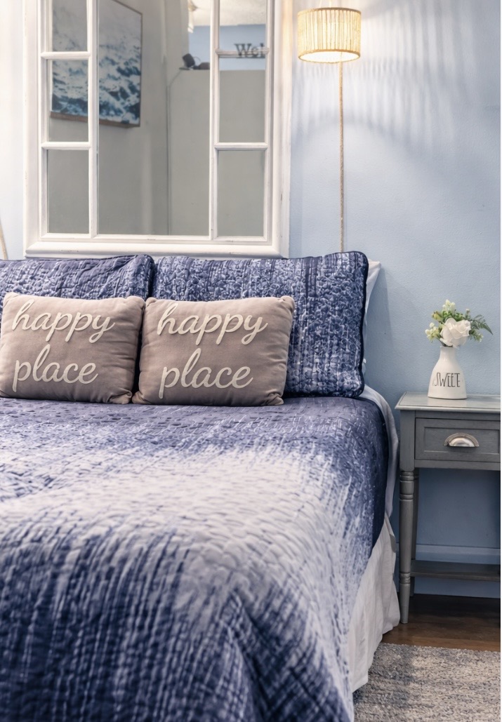 Minimalist bedroom with Soft rattan lighting to set the mood.
A warm, gentle glow complements the calming coastal palette, creating a relaxed, restful atmosphere. The queen bed invites you to unwind, recharge, and ease into peaceful vacation nights