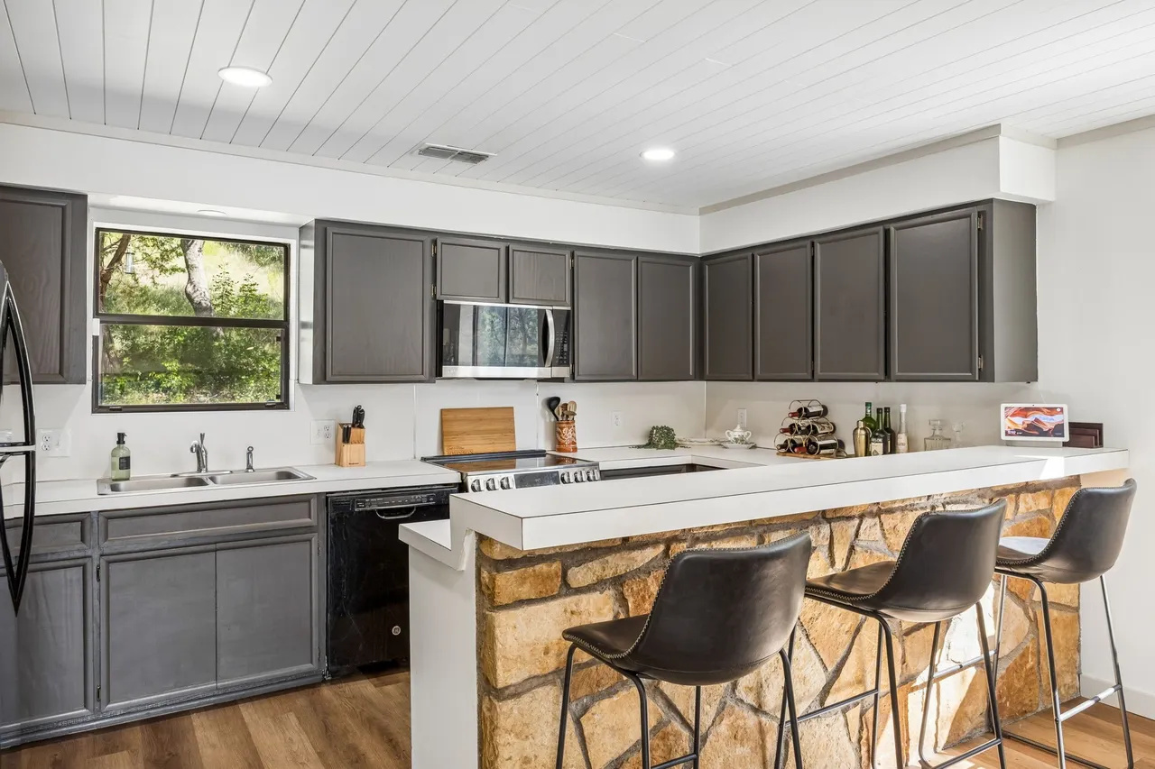 Spacious kitchen with island seating and lake-day essentials.