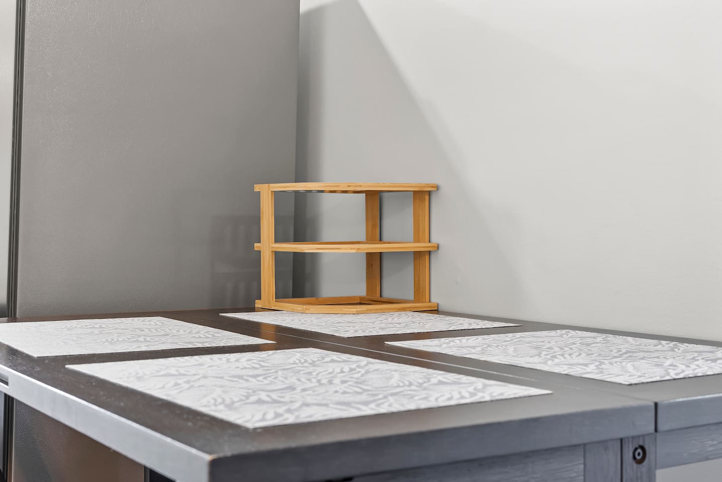 Close-up of the dining table set with placemats, ready for shared meals and conversation.