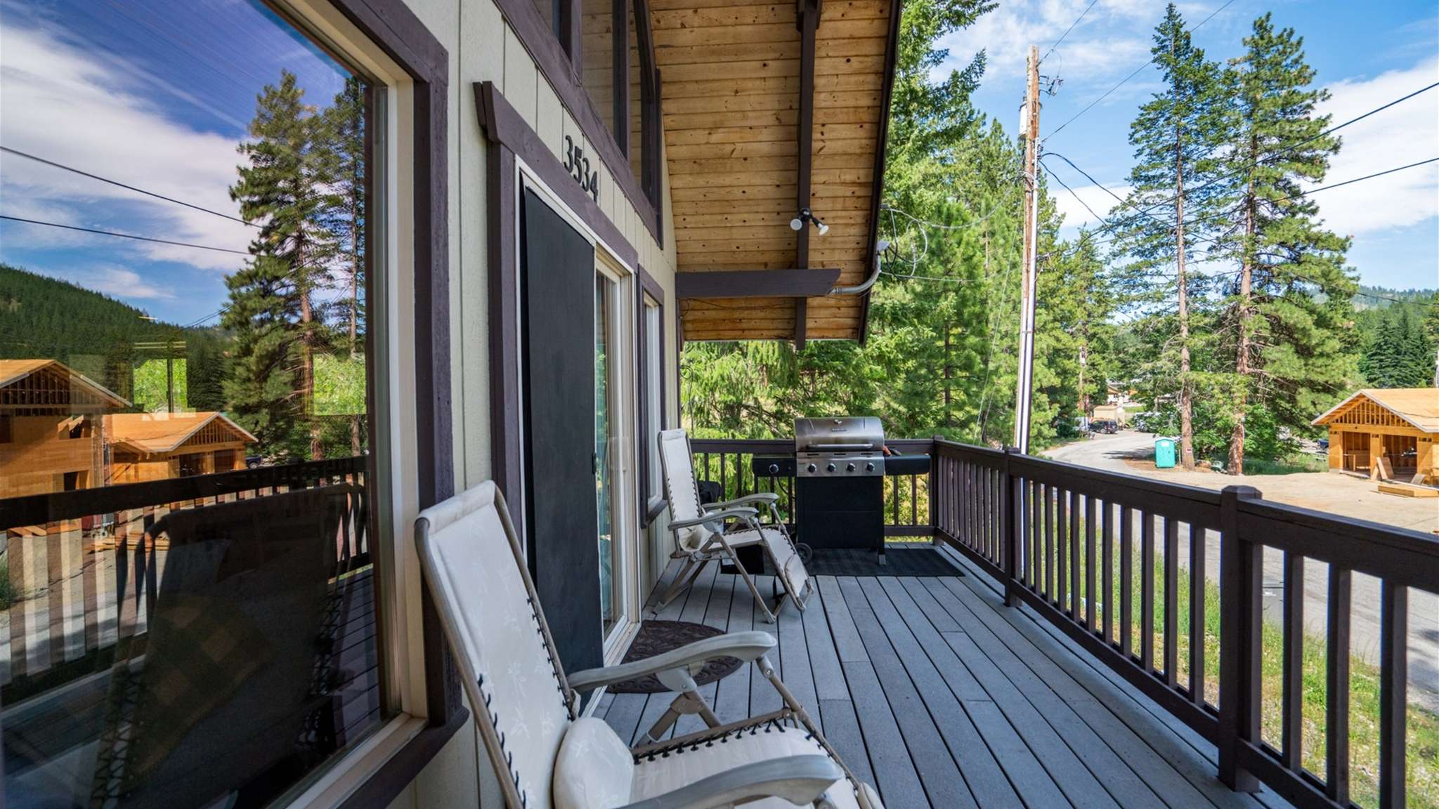Front deck surrounded by nature — great for lounging or outdoor dining.