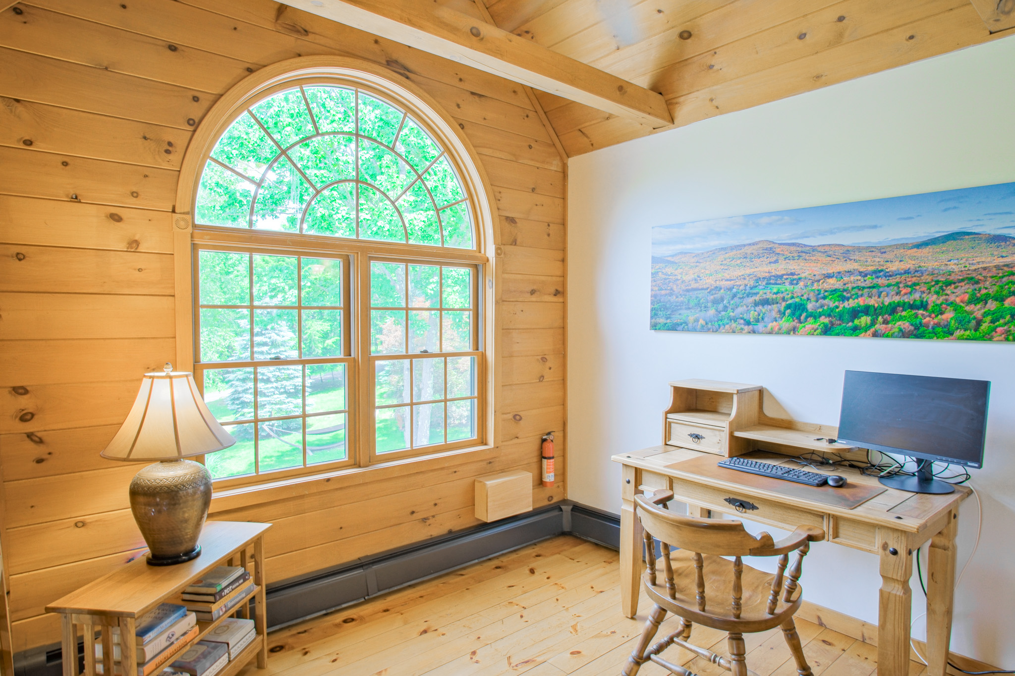 The mezzanine also offers a fully-functional work space. Monitor, keyboard, mouse, and fast wifi. Bonus: your zoom background will be the massive cathedral ceiling of the family room