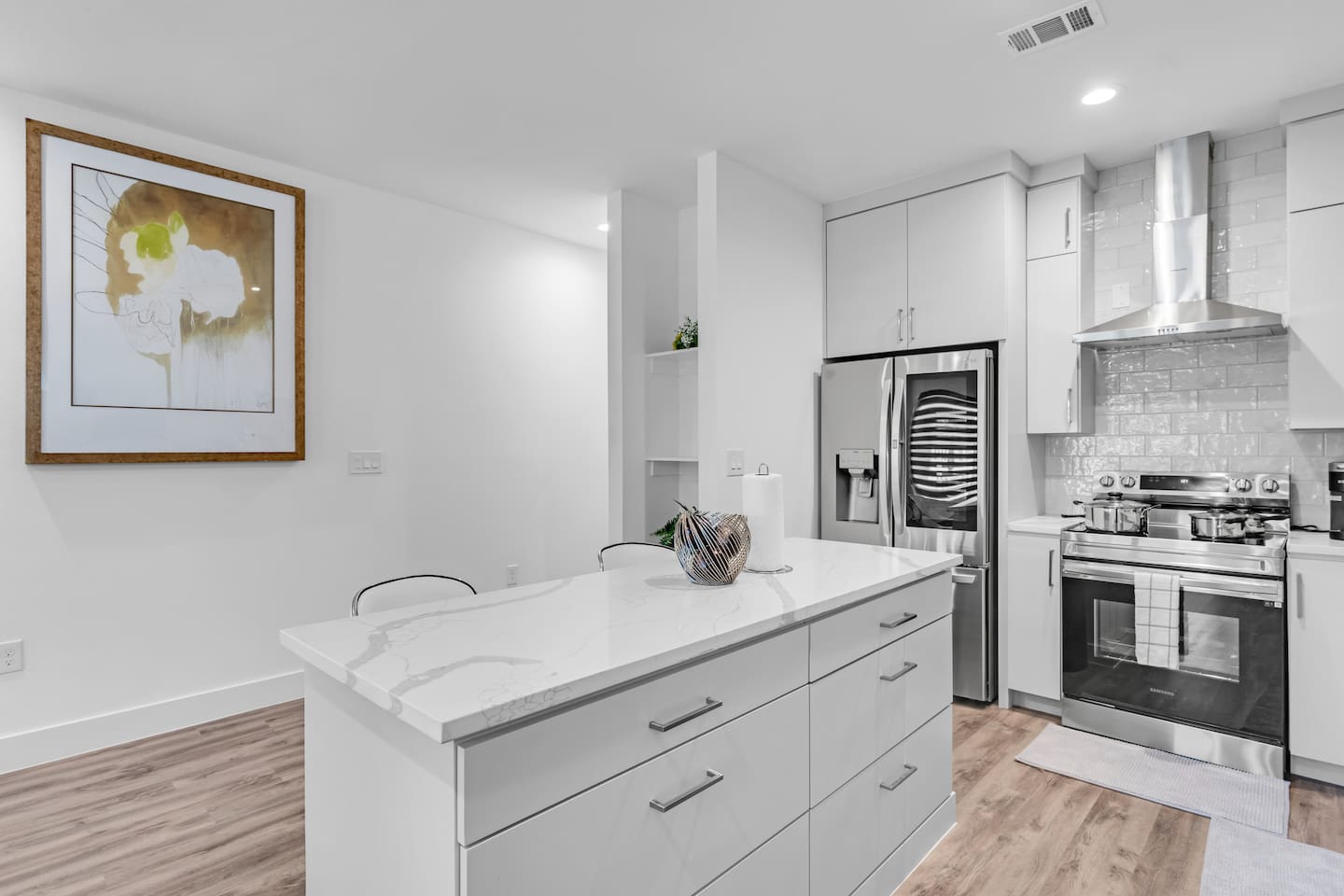 Brand new, open-concept kitchen with stainless steel appliances and island.