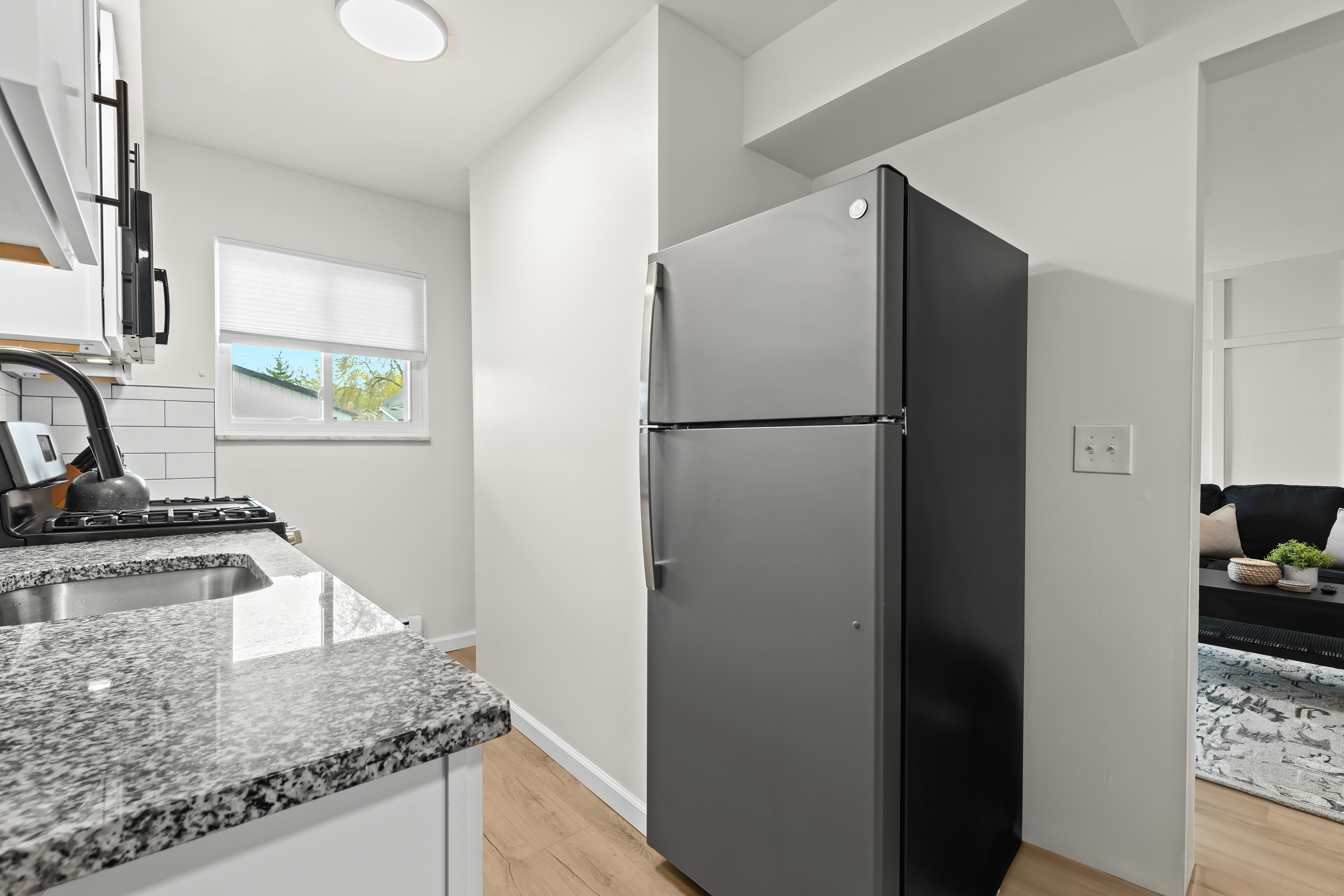 Spacious kitchen with full-size fridge and modern appliances—everything you need for a comfortable stay.