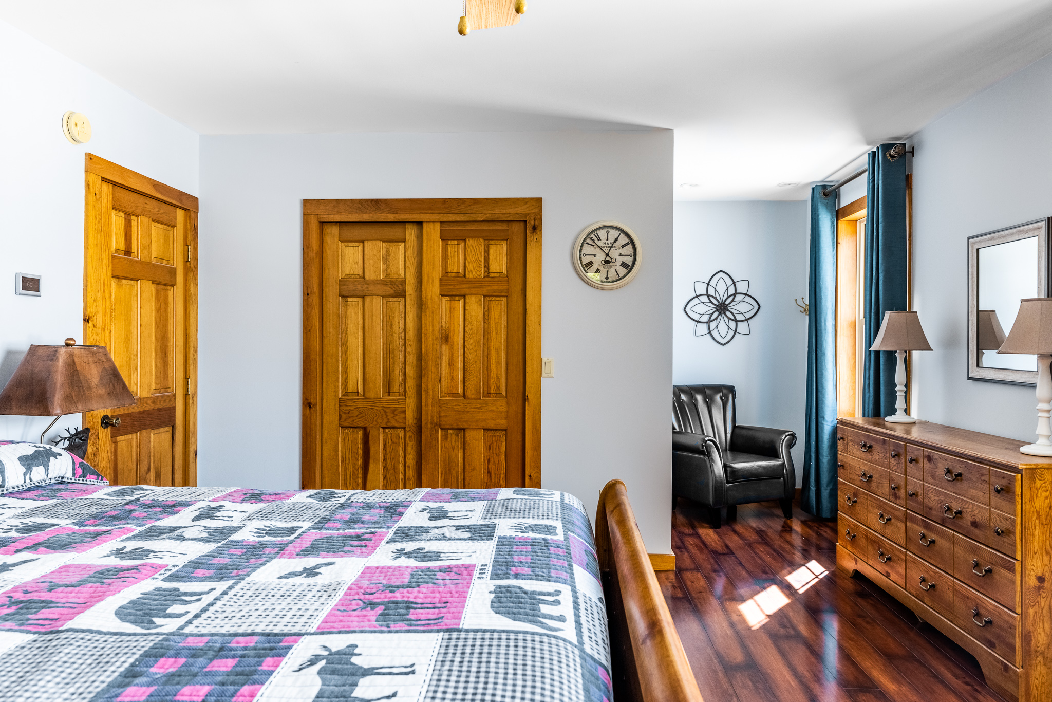 Upstairs bedroom with a queen bed  and reading area overlooking the lake