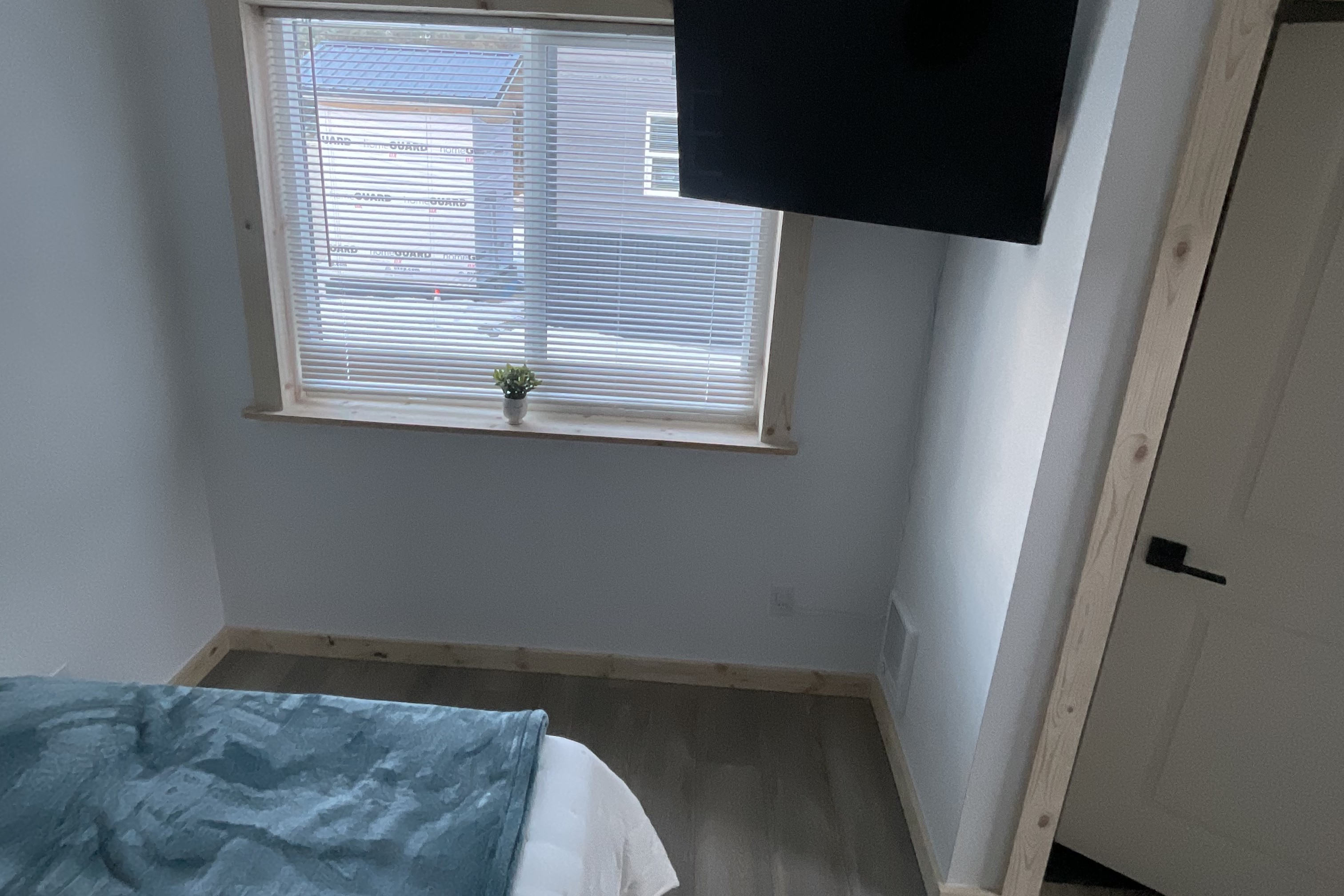 Bedroom on main floor includes a Queen Size Bed with night stand, closet space and TV. 