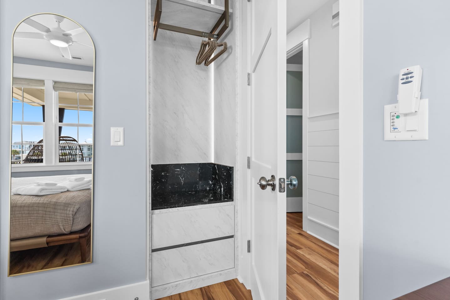 Built-in wardrobes provide ample clothing and luggage storage with two drawers, a hanging bar, and two shelves.