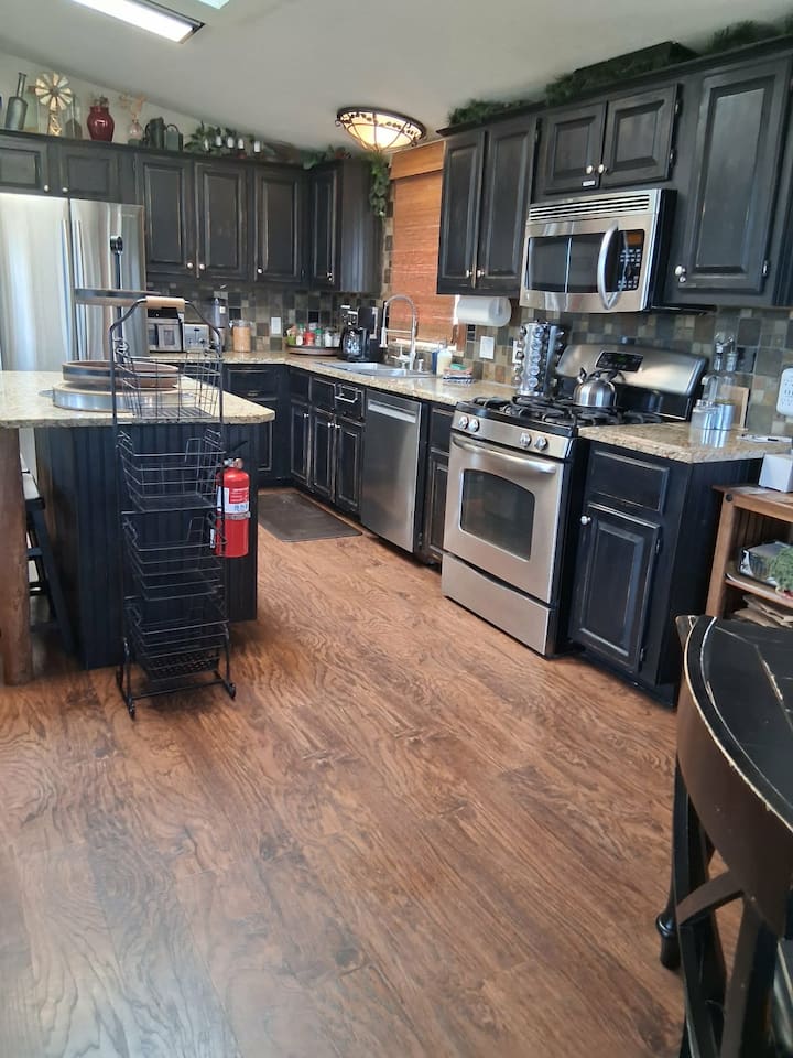 The Kitchen has high-end appliances: browning microwave, dishwasher,  gas stove & more.  It is stocked with cookware for any occasion, and an assortment of spices.