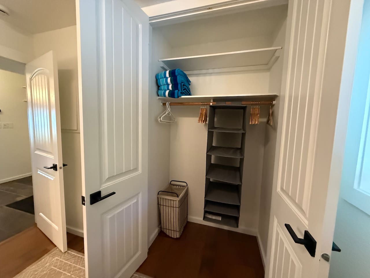Ample storage in the full size closet with an organizer as a smart storage solution for compact spaces. 