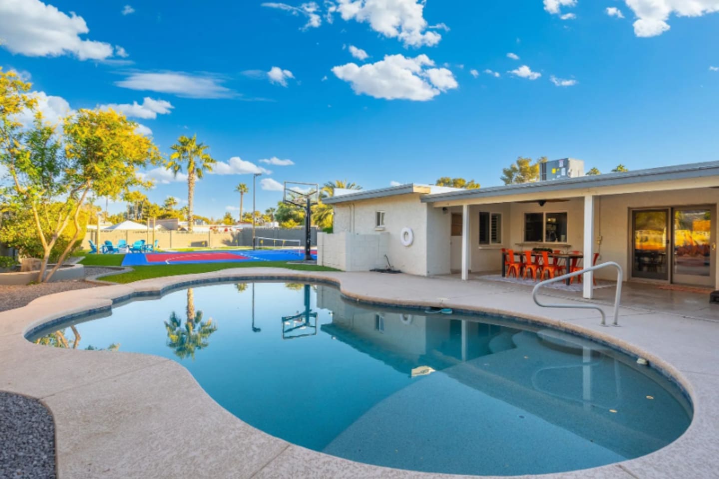 The pool curves right up to the covered patio, keeping indoor and outdoor living seamlessly connected.
