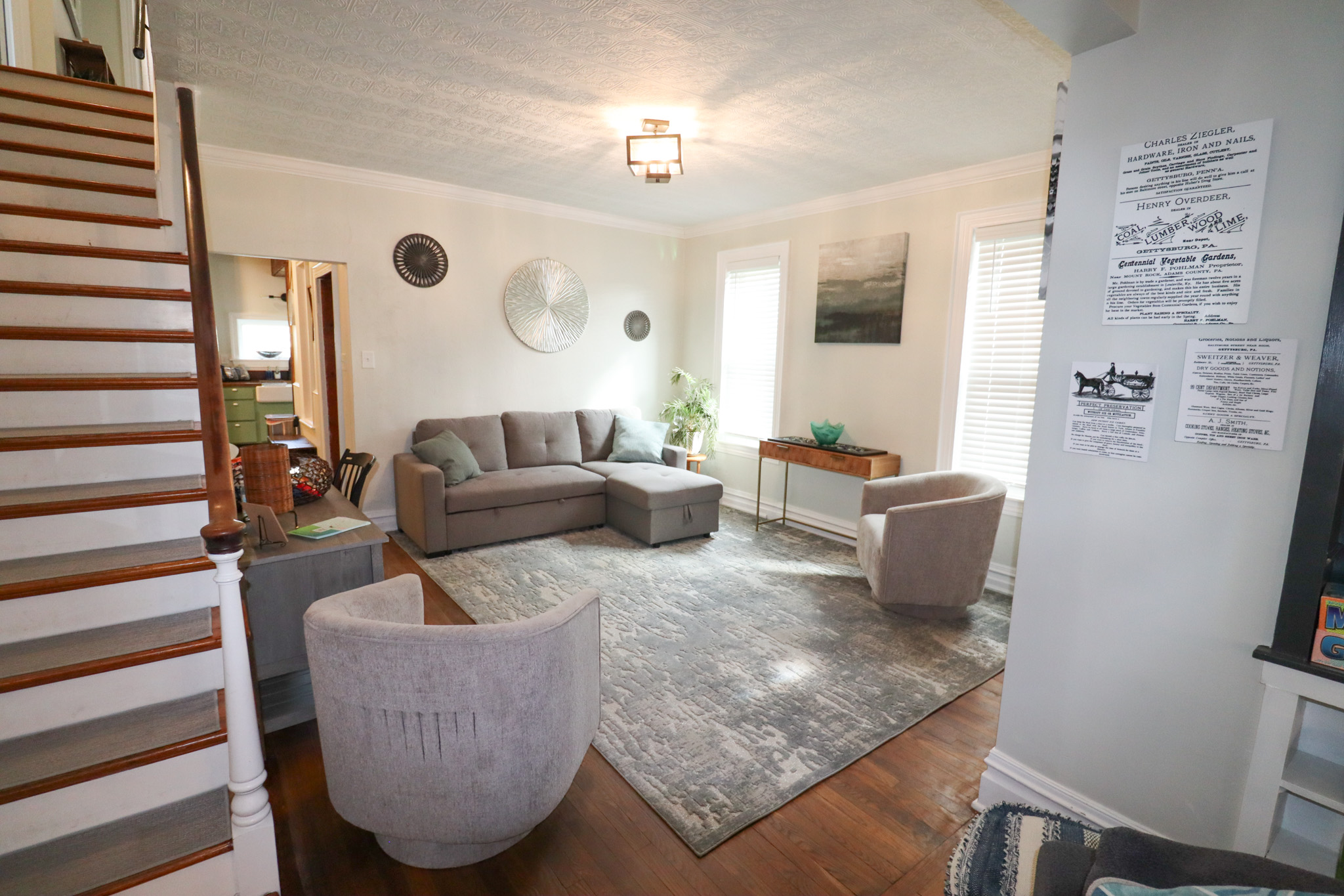 open concept lving area with plenty of seating reading lamps and natural light from surround windows.