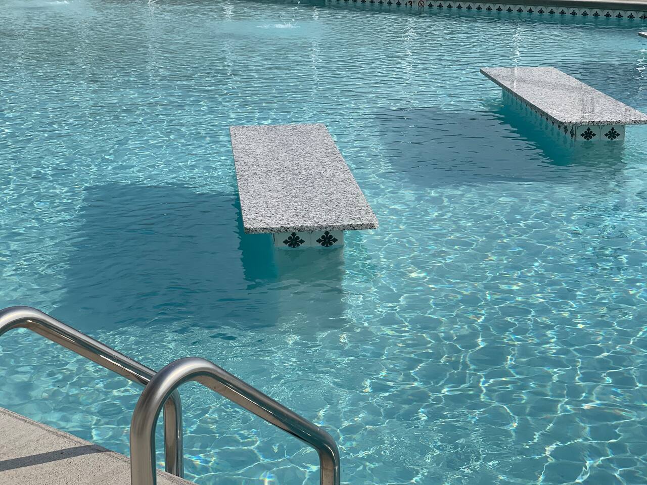 Pool 2 has adult tables in the deep end and fountains. 