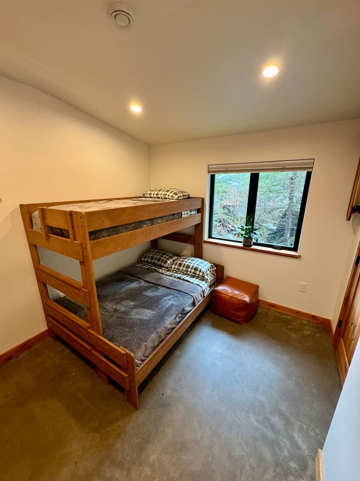 Guest bedroom with twin over full bunkbed and room darkening shades