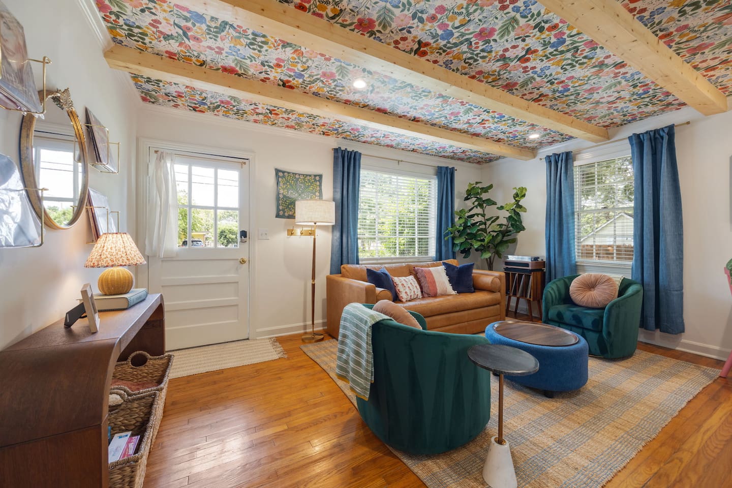 Escape to this charming retreat - super convenient for exploring Franklin. Living room features a record player, electric fireplace, leather couch with pull-out sofa bed, and a small desk.