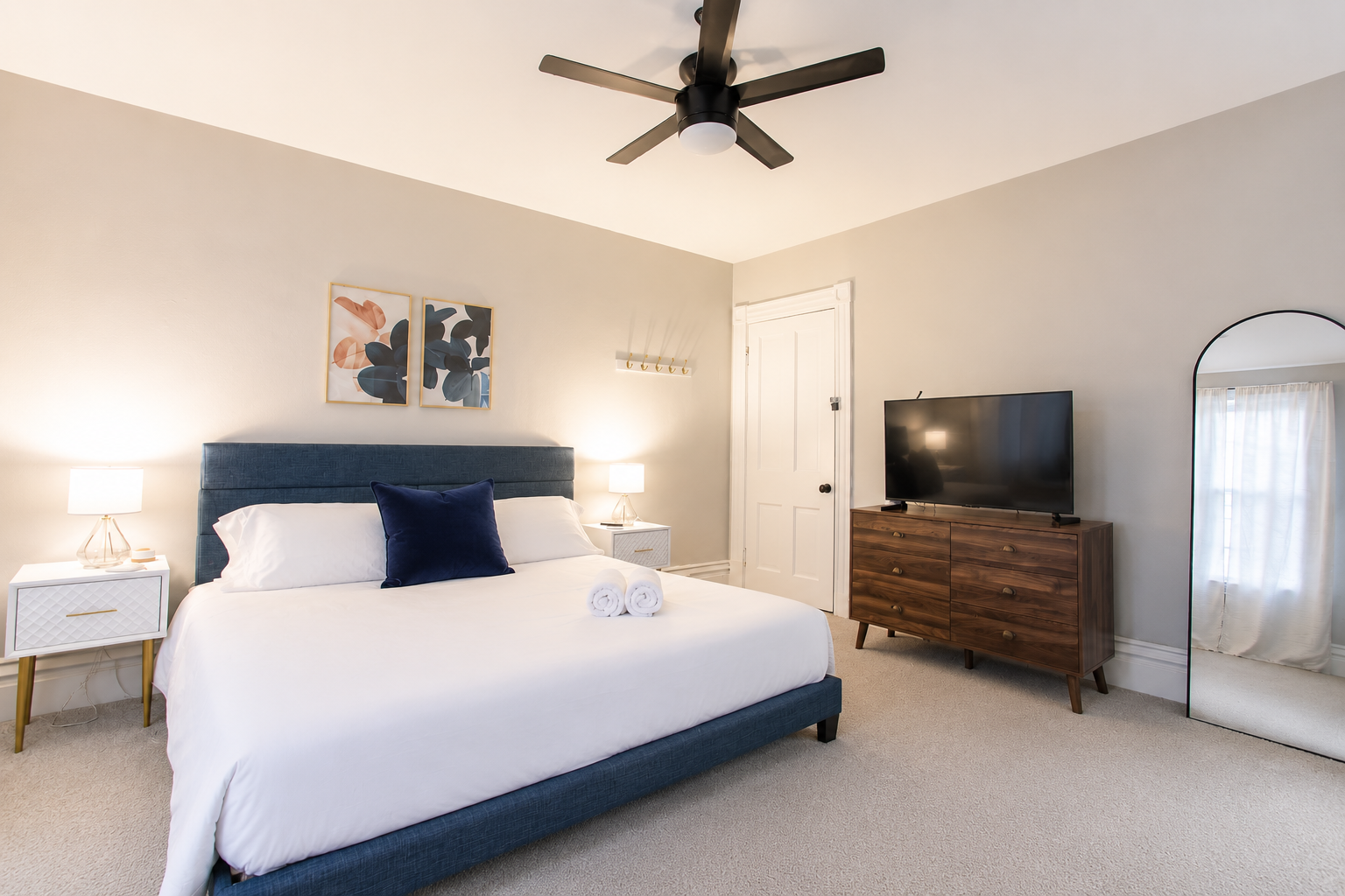 Discover the King Bedroom, a spacious room on the second floor with king bed flanked by nightstands with lamps.