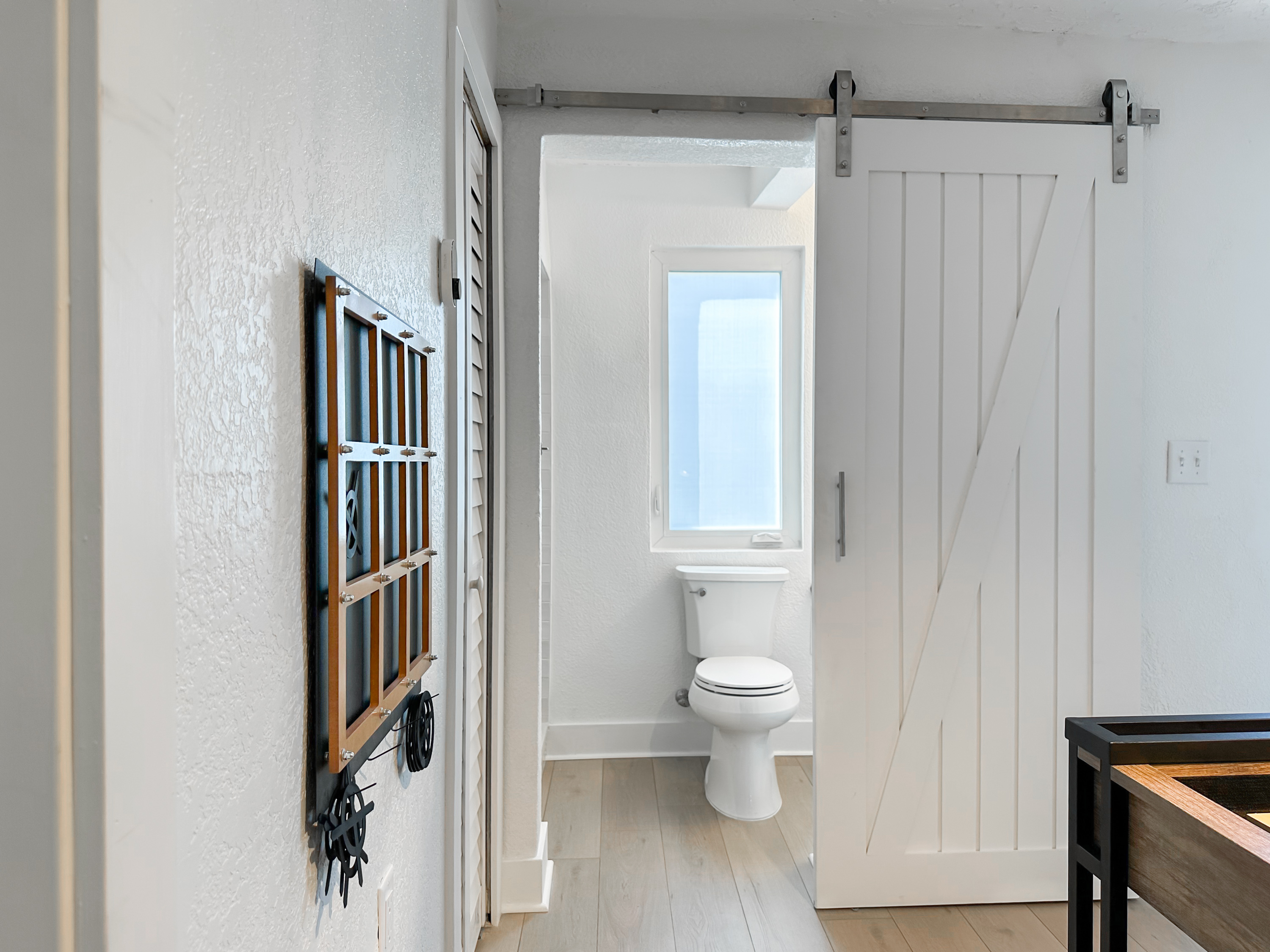 The bathroom is right behind the barn doors.