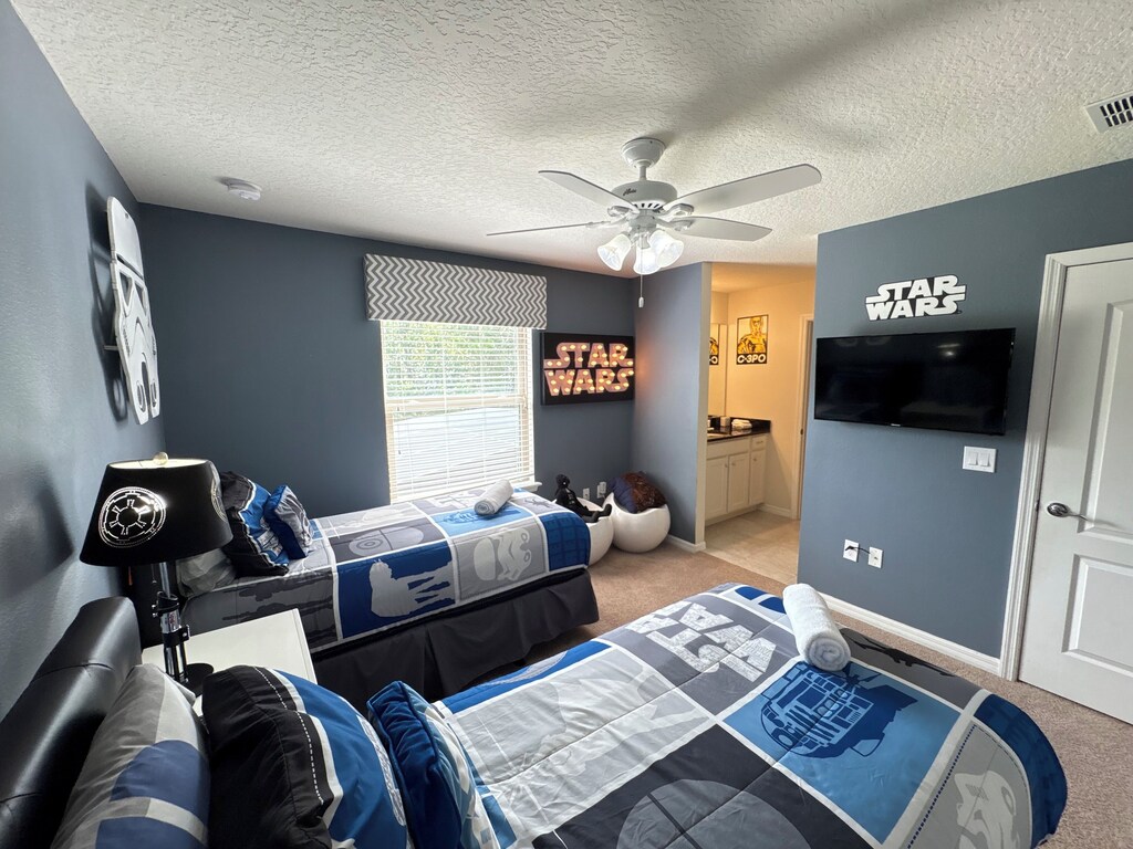 Star Wars themed room with decorative lights and characters and adjoining bath