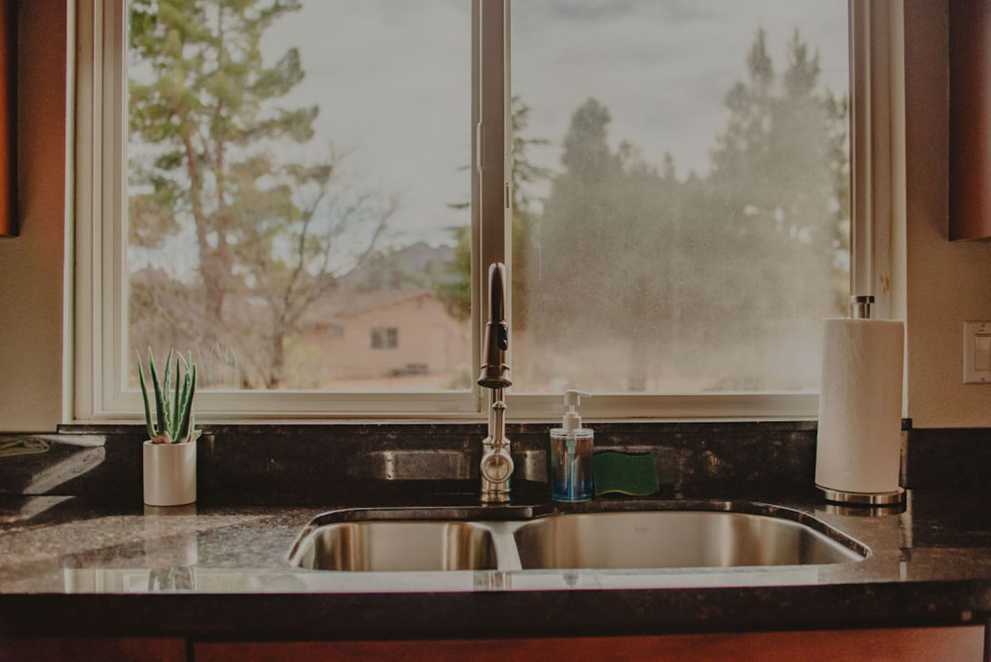 Kitchen sink with natural light and views of the surrounding neighborhood