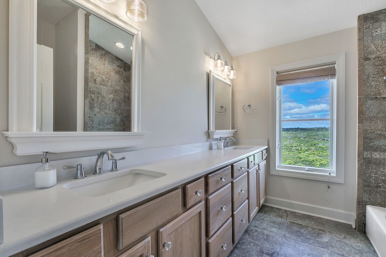 Large upstairs shared double vanity bathroom with views of Guana State Park