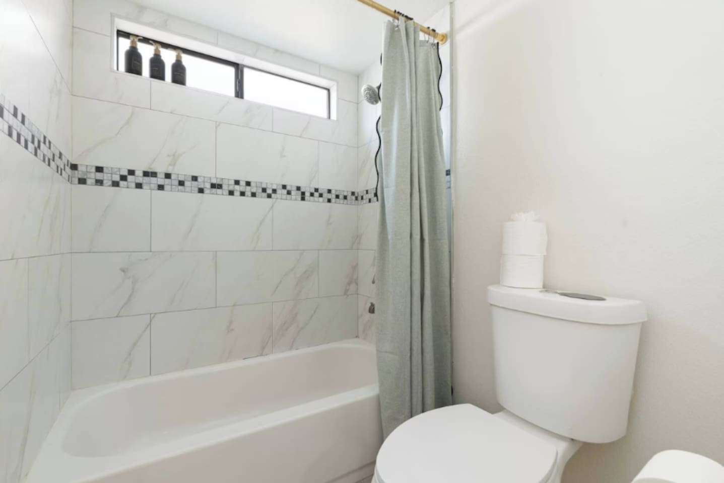 Clean and bright bathroom with marble tile, soaking tub, and skylights—spa-quality spaces designed for comfort and relaxation.