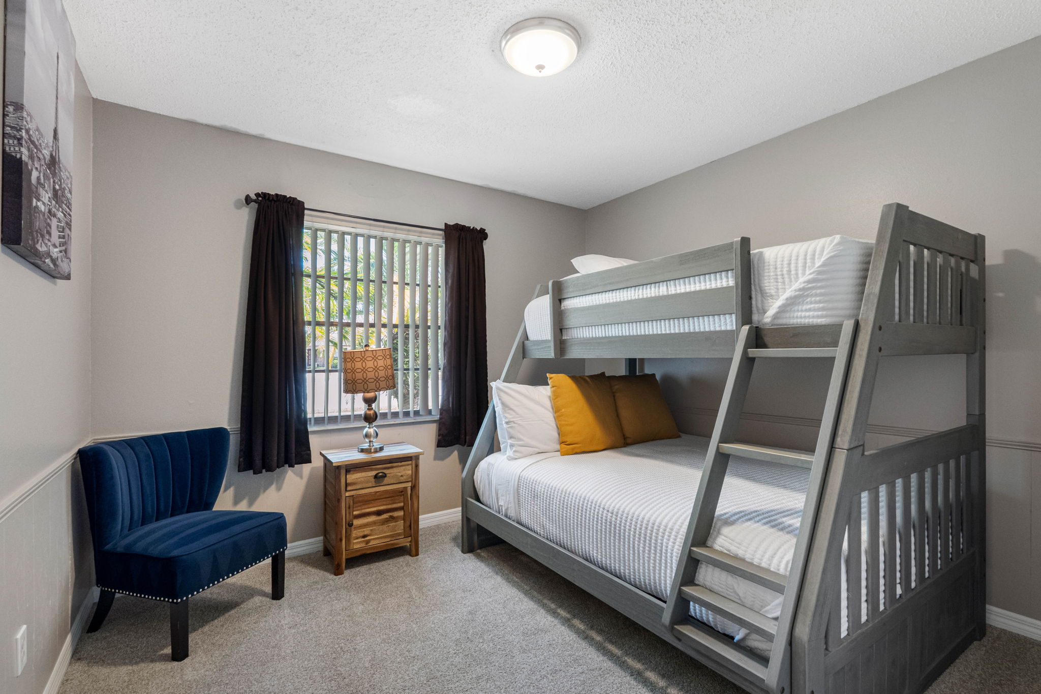 This cozy bedroom features a twin-over-full bunk bed, perfect for accommodating both kids and guests in comfort.
