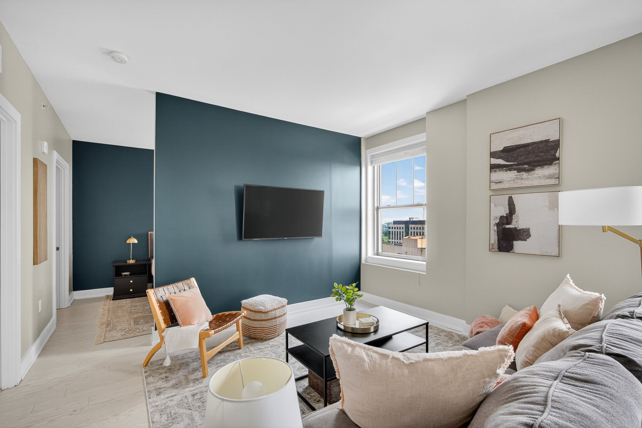 Bright, modern living room with stylish accents, downtown views, and a cozy setup perfect for relaxing or streaming your favorite shows.