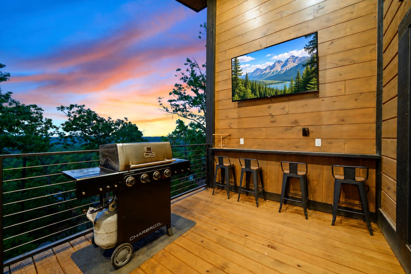 Outdoor living at its best—grill dinner, grab a seat at the bar, watch TV, and take in the stunning sunset and mountain views from the deck.