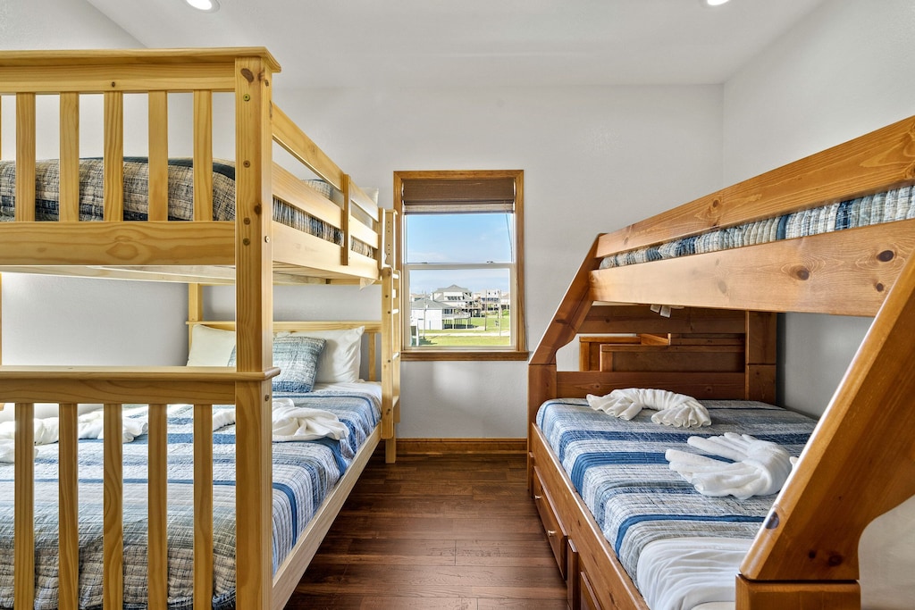 Secondary bedroom with custom-made queen-over queen and twin XL bunk beds. 