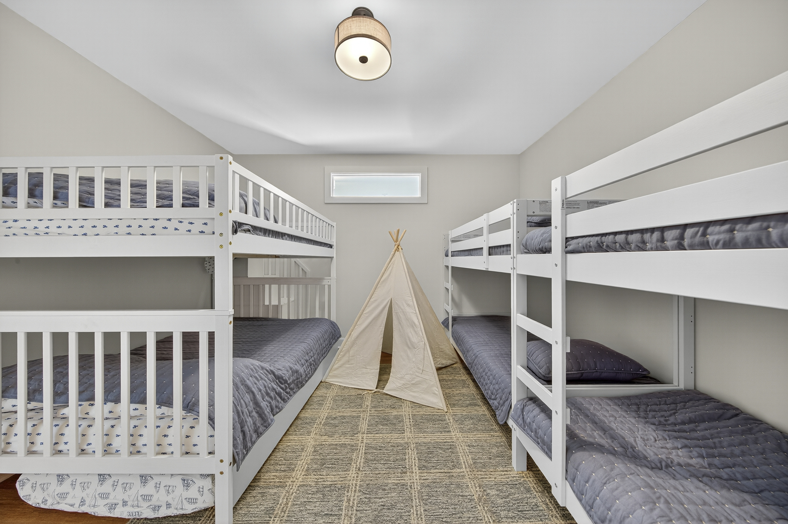 The ultimate kids’ hangout—bunk beds, doubles, a twin, and even a teepee for adventures!