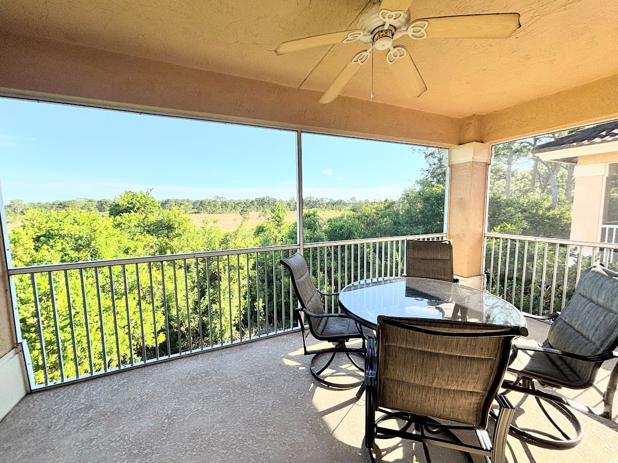 Spacious screened balcony offering plenty of room to relax, dine, and enjoy the outdoor views.