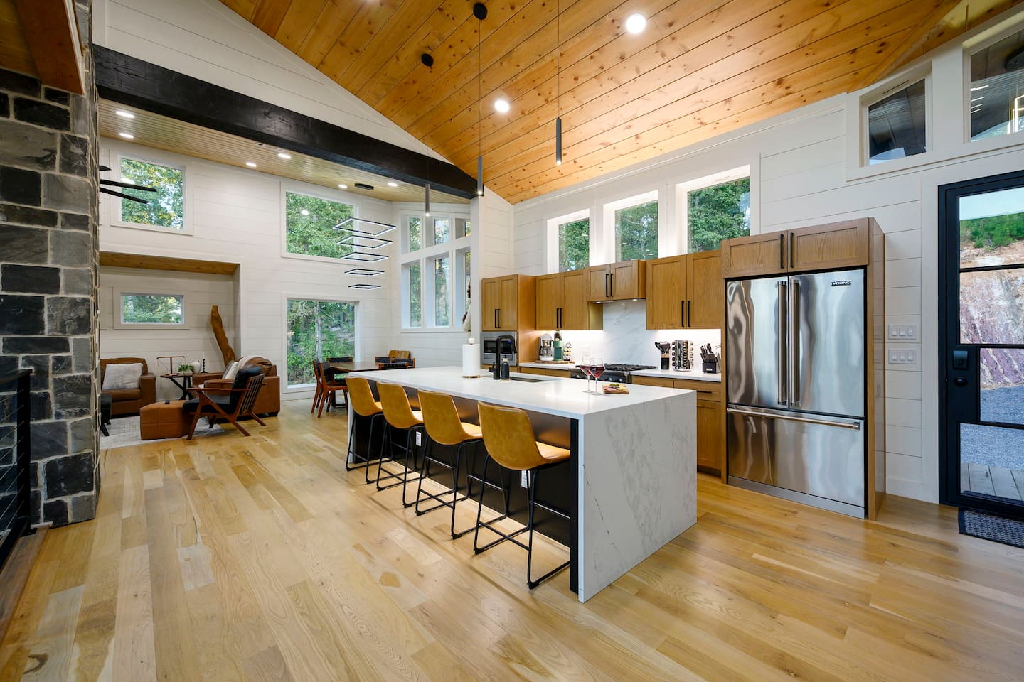Upper-level kitchen beside the dining and living areas.