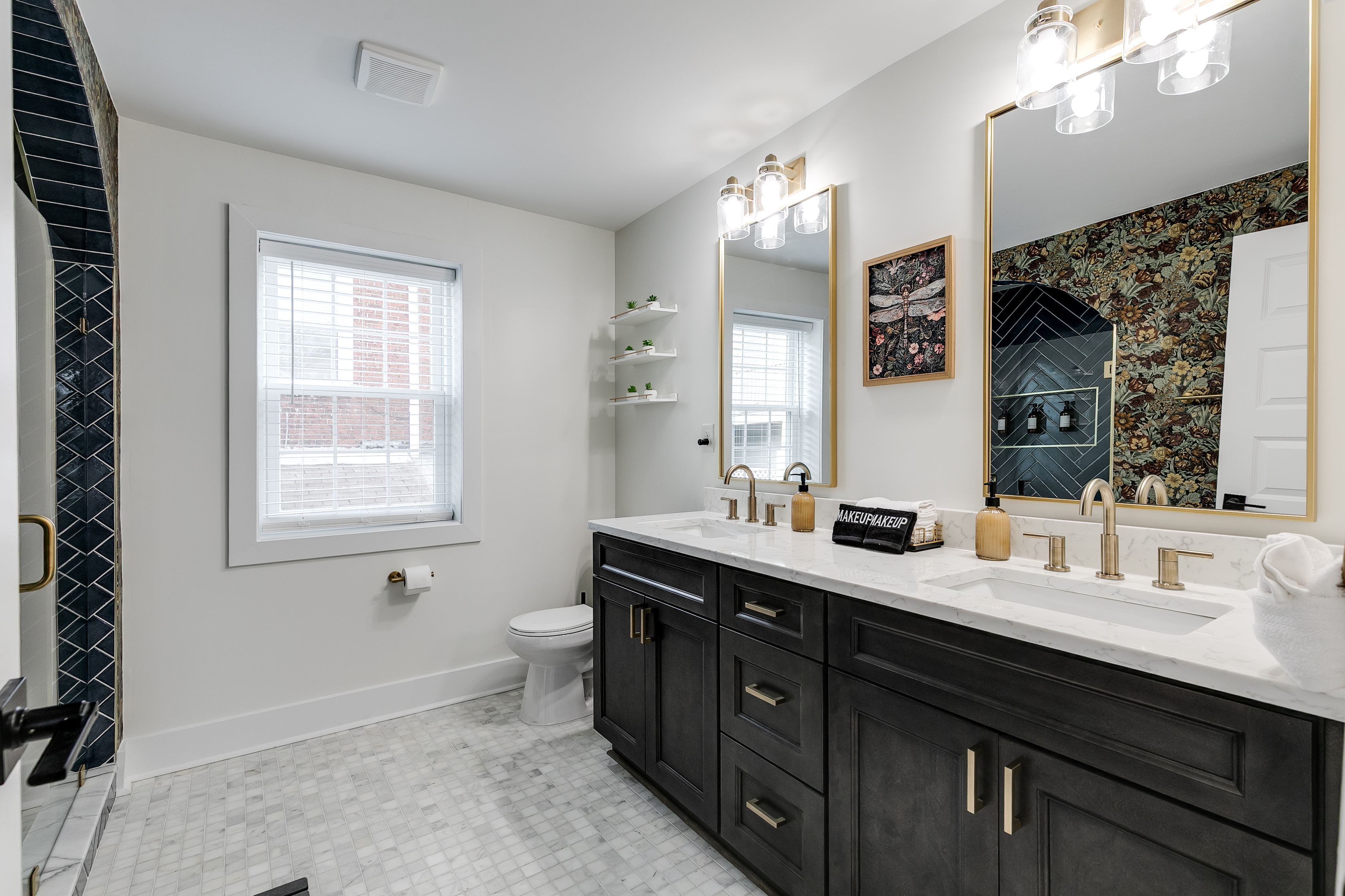 Luxurious Bathroom: Stylish dual sinks, elegant lighting, and floral accents create a refreshing retreat!