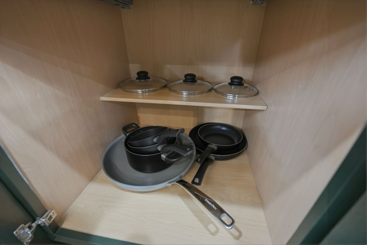 Cookware cabinet featuring pots, pans, and lids so you’ll have everything you need for cooking during your stay.