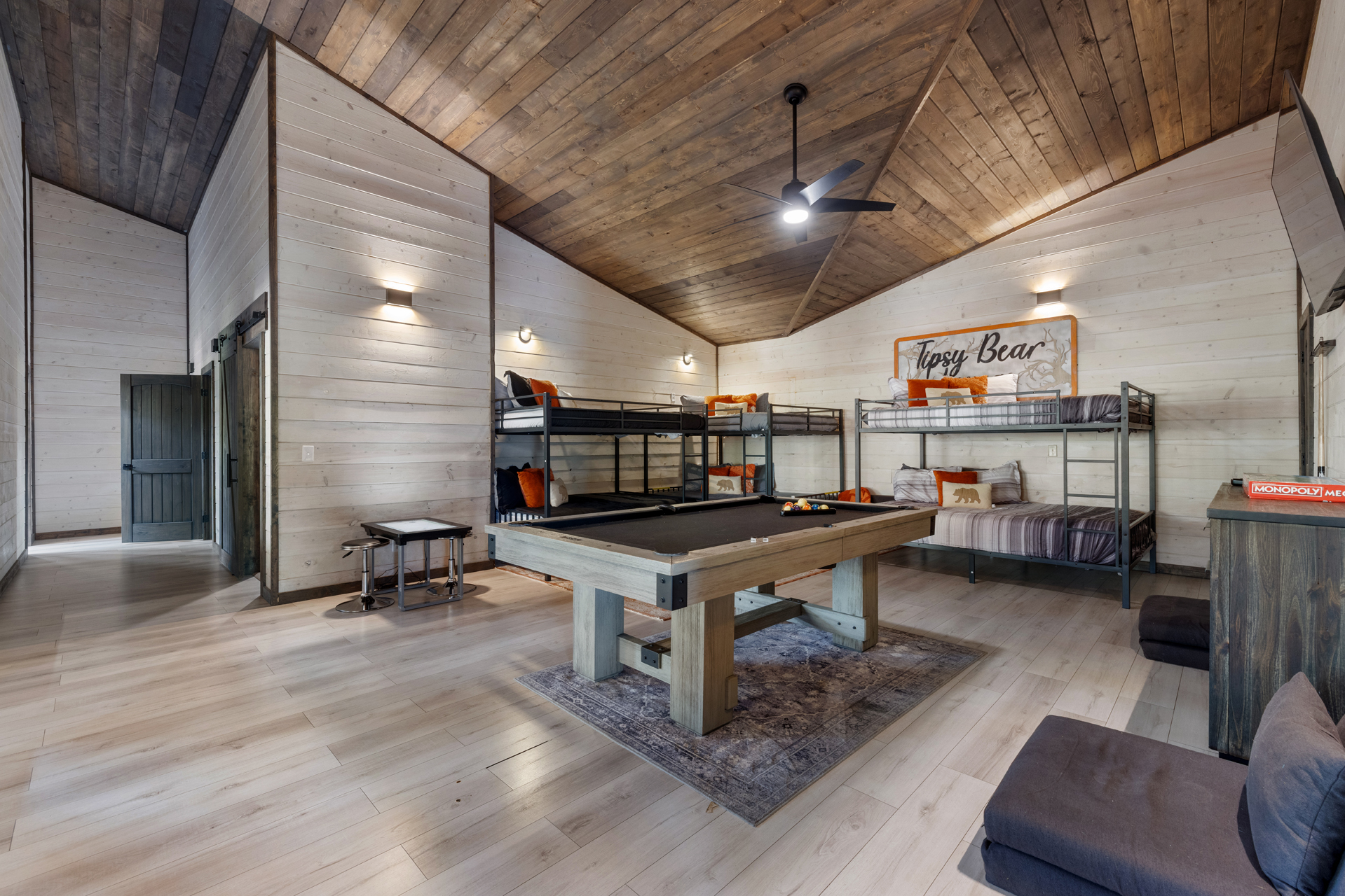 In this gameroom/bunkroom, you’ll find sleeping accommodations for 8, with full-on-  queen bunk beds.