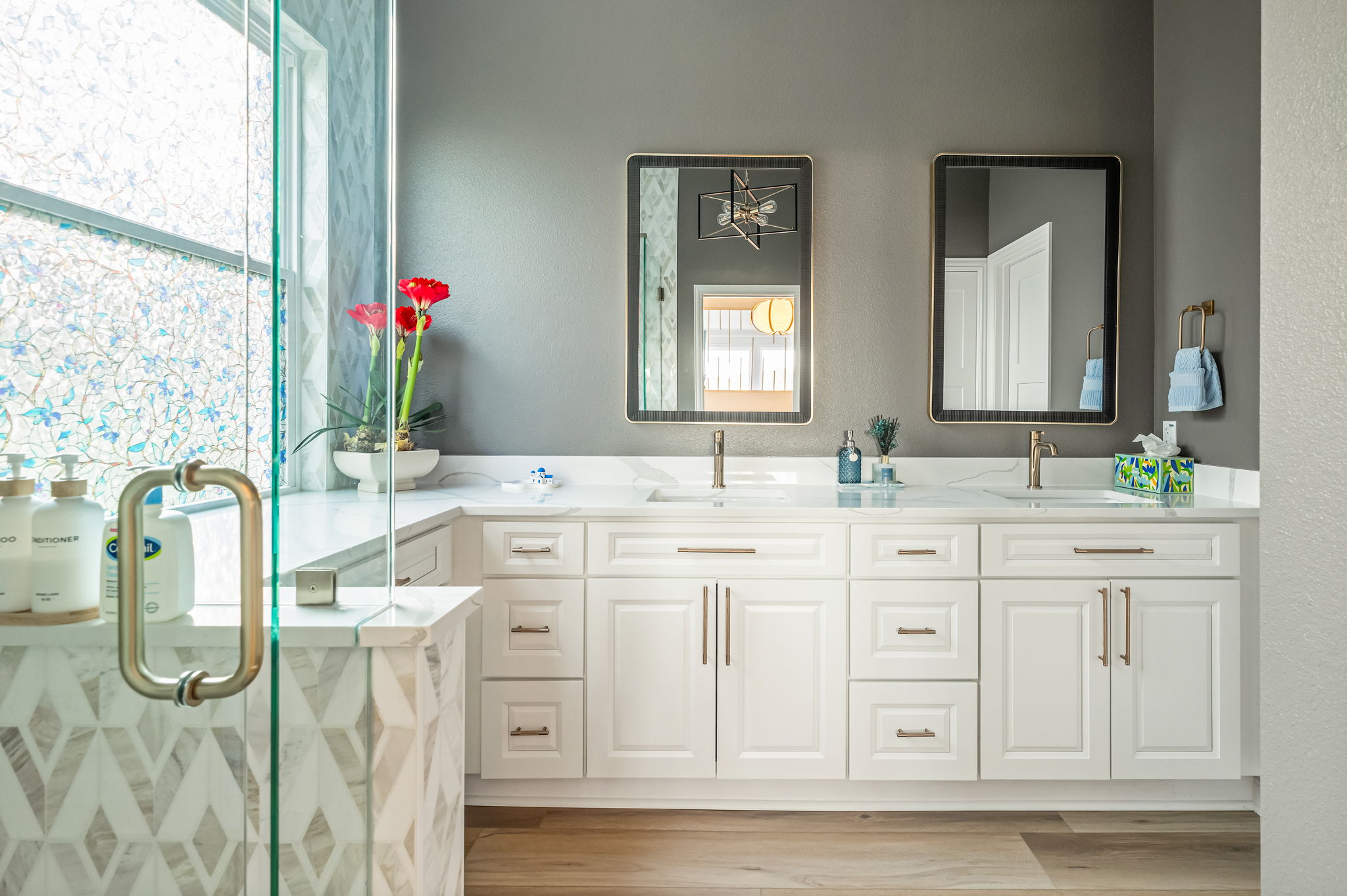 Spacious luxury bathroom with dual sinks and glass walk-in shower.