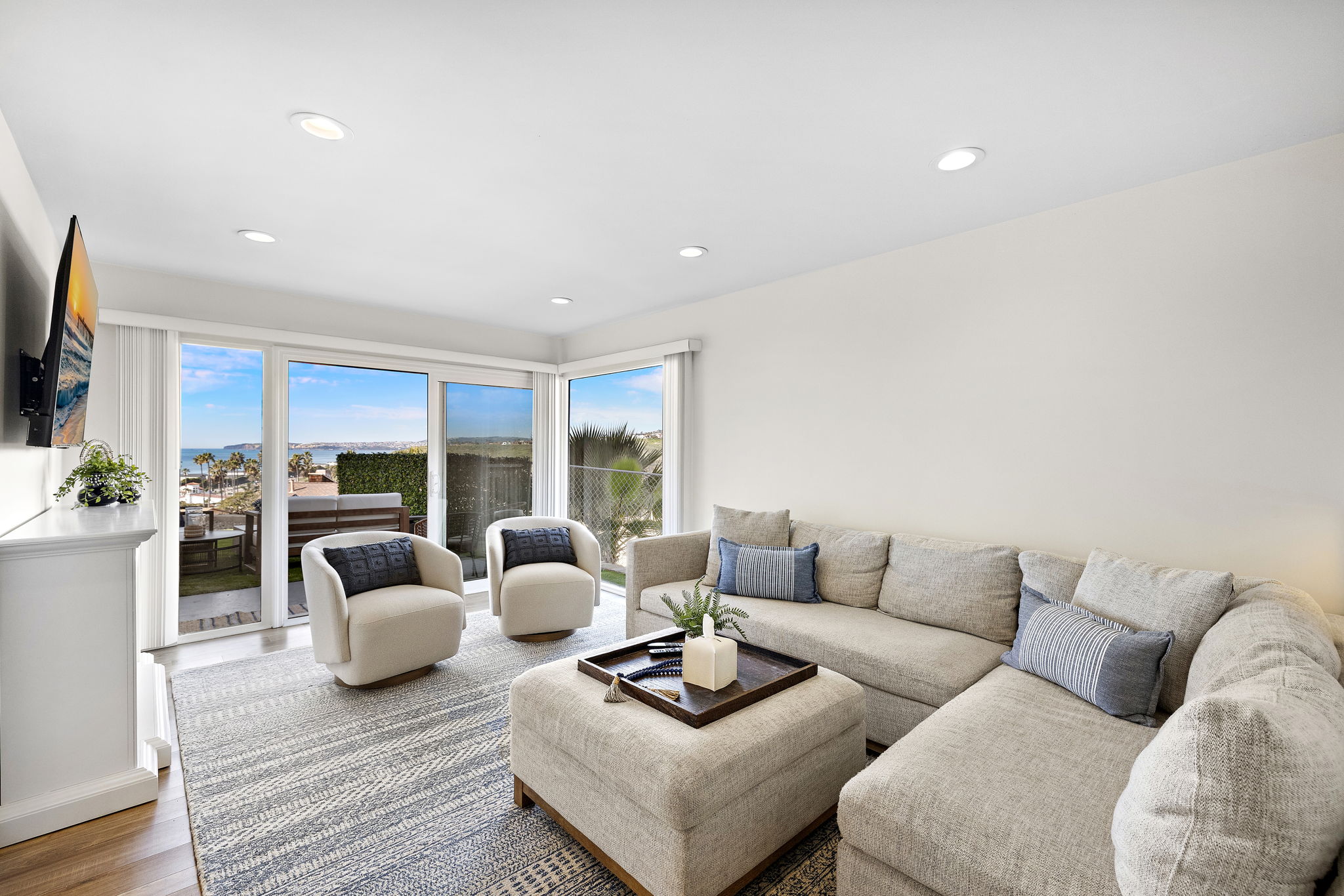 New listing from hosts with 4.99 star rating.  The living room has lots of comfortable seating, views and natural light pouring in from the back yard.