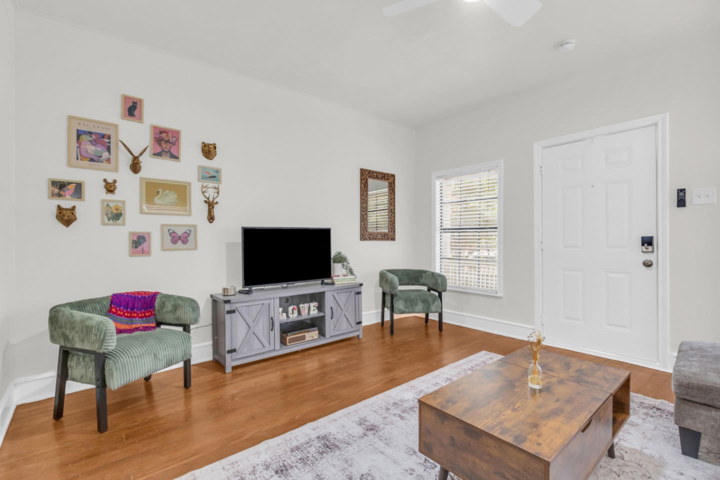 Living area with sectional sofa, TV with Roku, and open layout.
