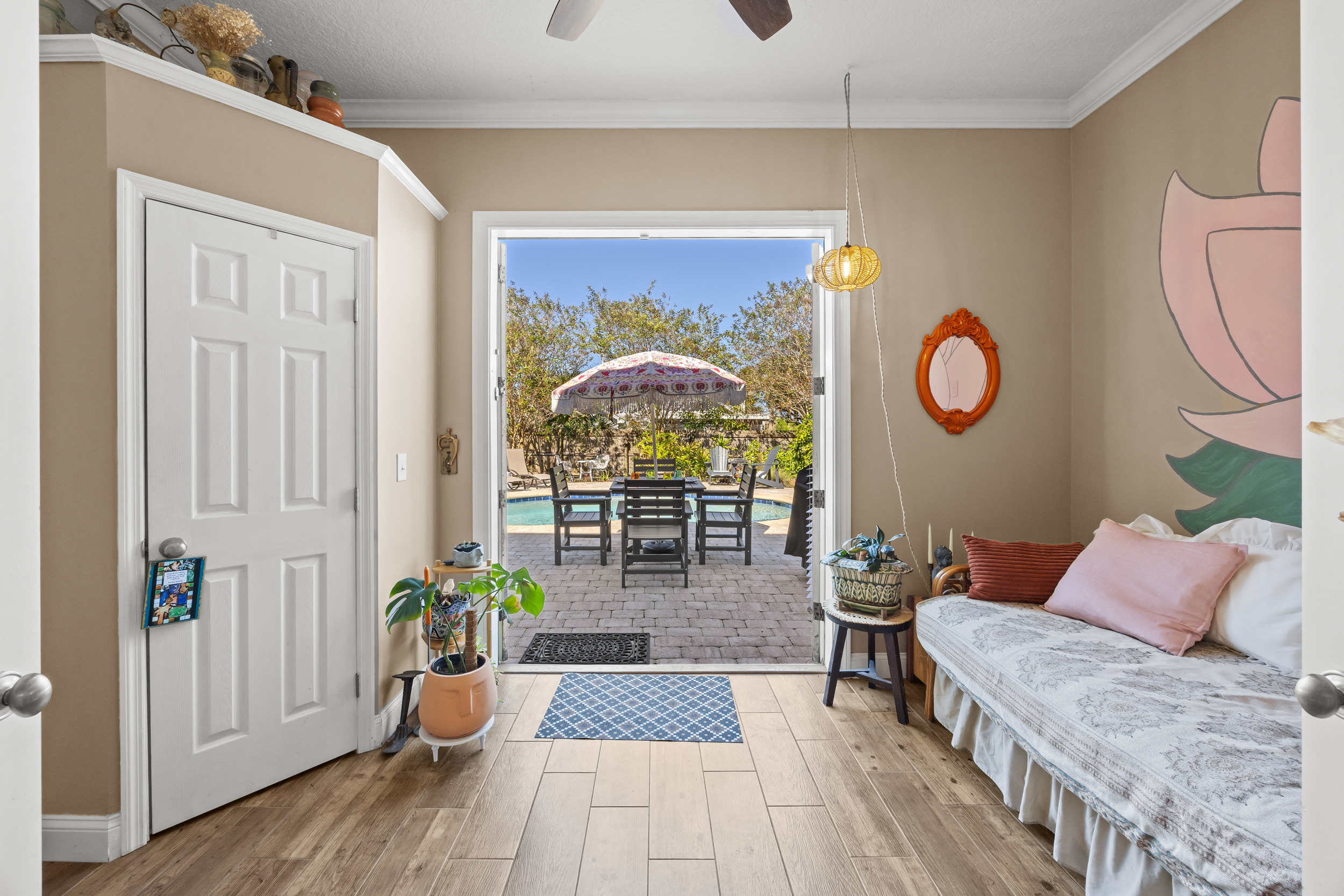 Indoor‑outdoor living with daybed room opening directly to the patio and private pool.