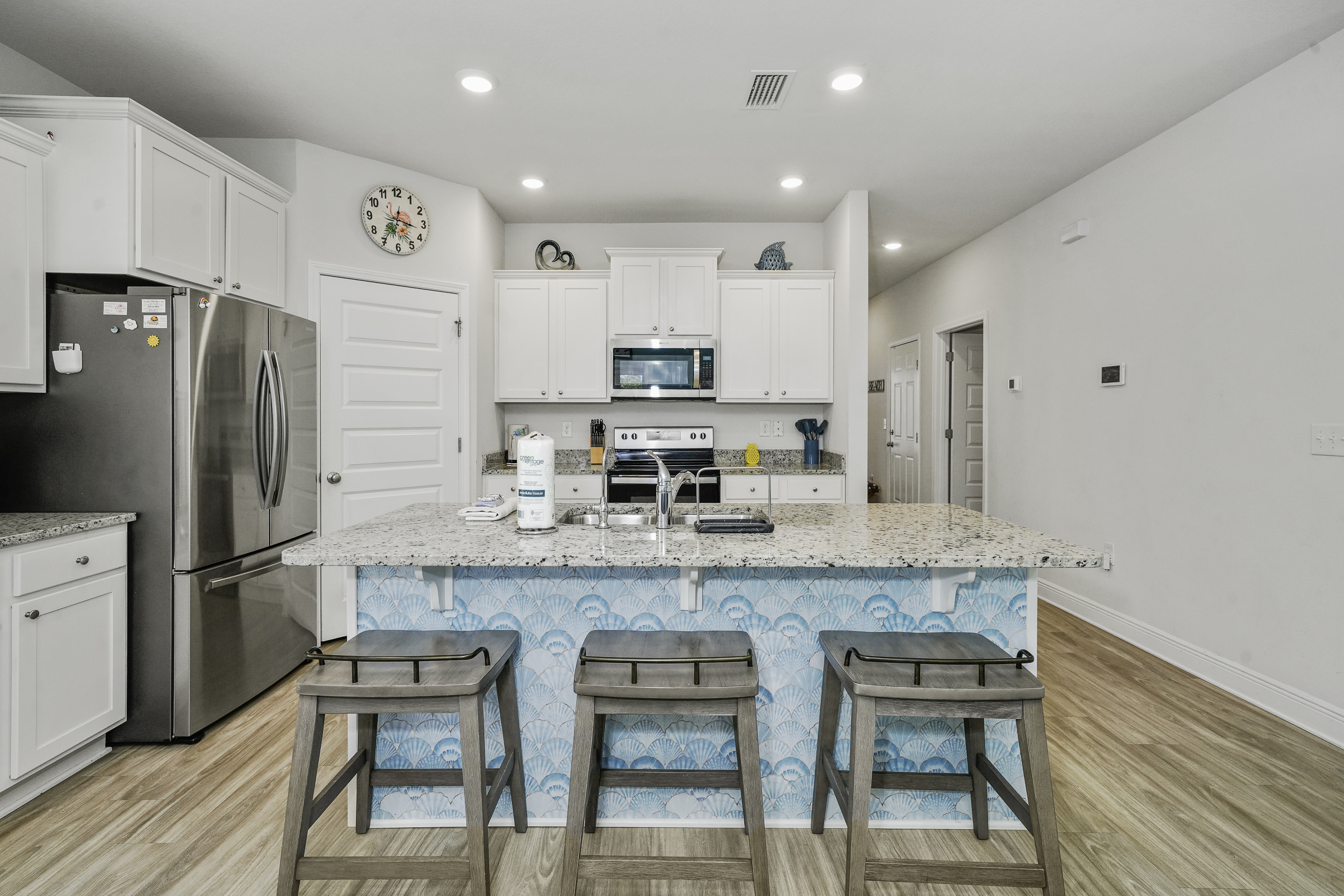 Fully stocked main kitchen with 3 bar stools