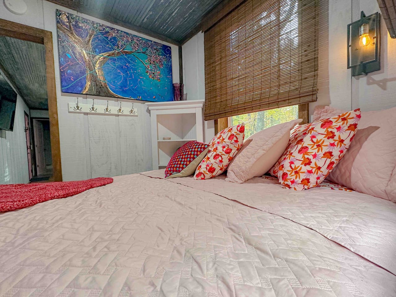 Original artwork, bamboo window shades on all three bedroom windows, and 100% cotton bed linens give this bedroom a cozy, comfortable feel. 