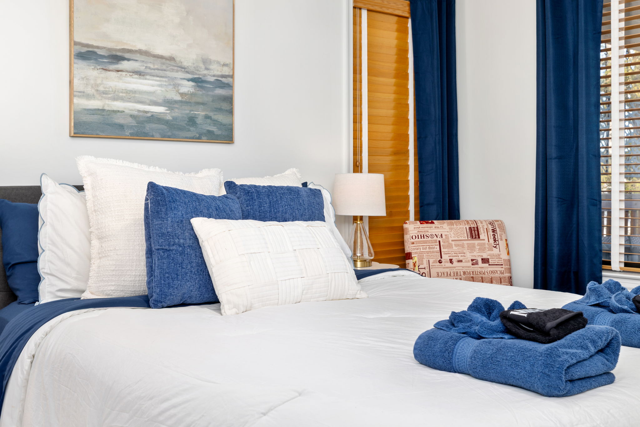 Charming Bedroom 1: Unwind in style with plush pillows and warm lighting for peaceful nights!